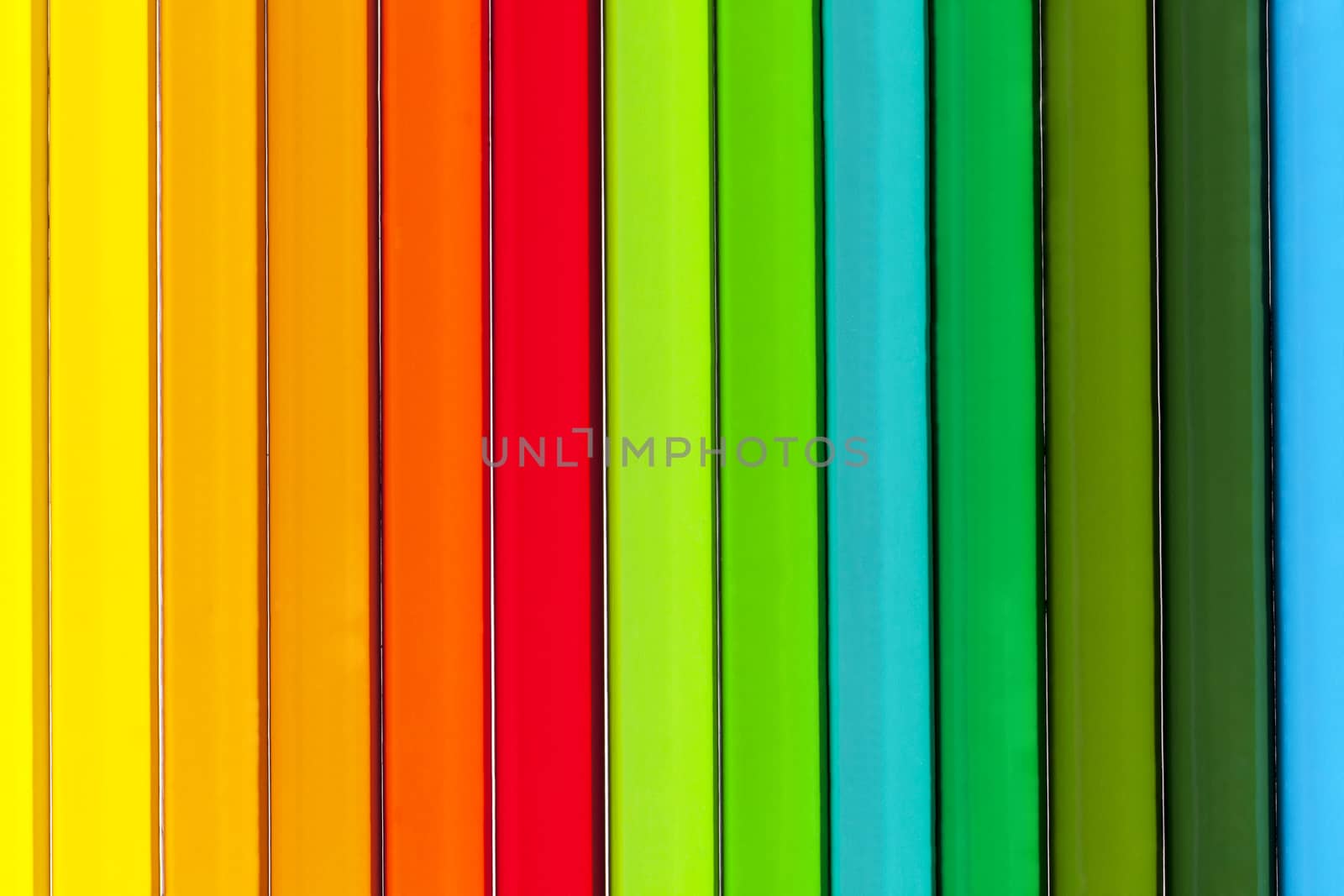 Background of parallel colorful pencils, close up