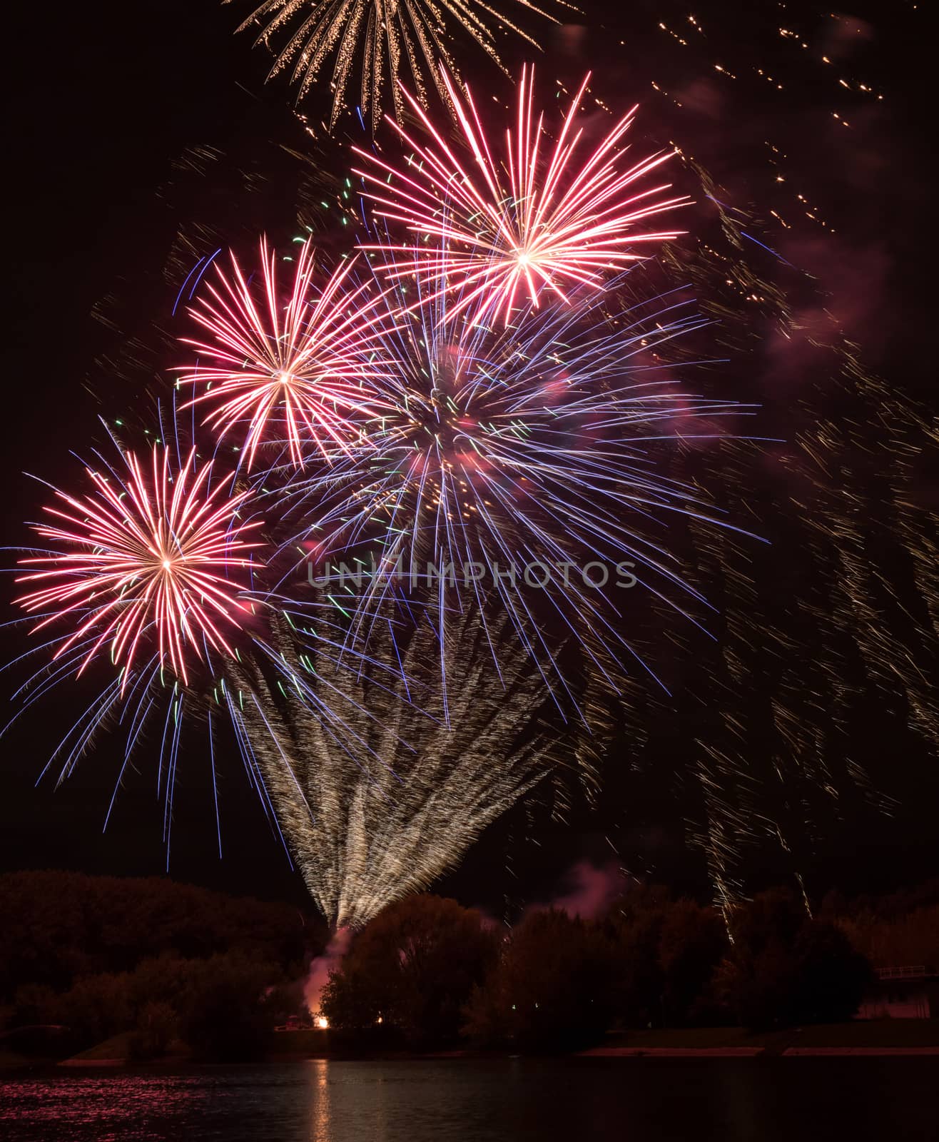 Brightly colorful fireworks and salute of various colors in the night sky background