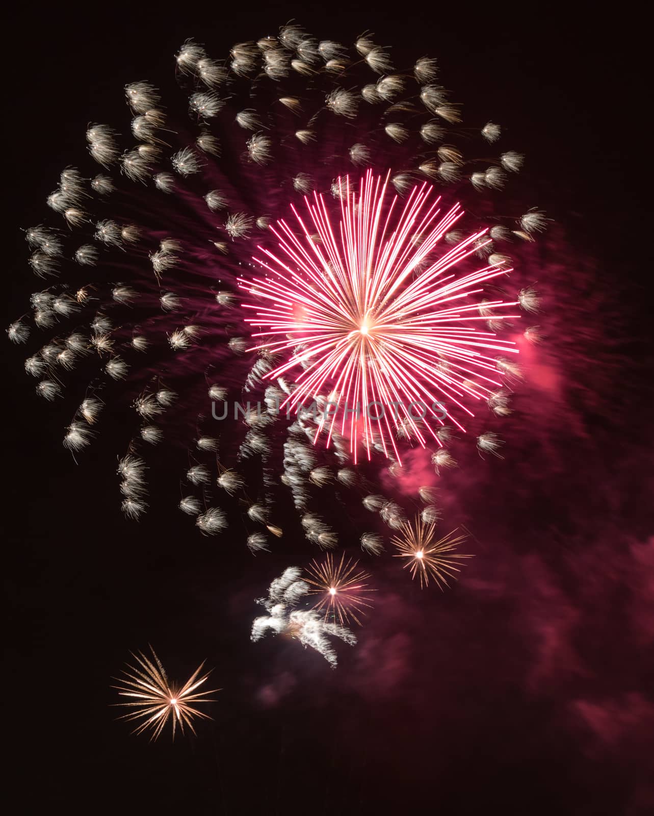 Brightly colorful fireworks and salute of various colors in the night sky background