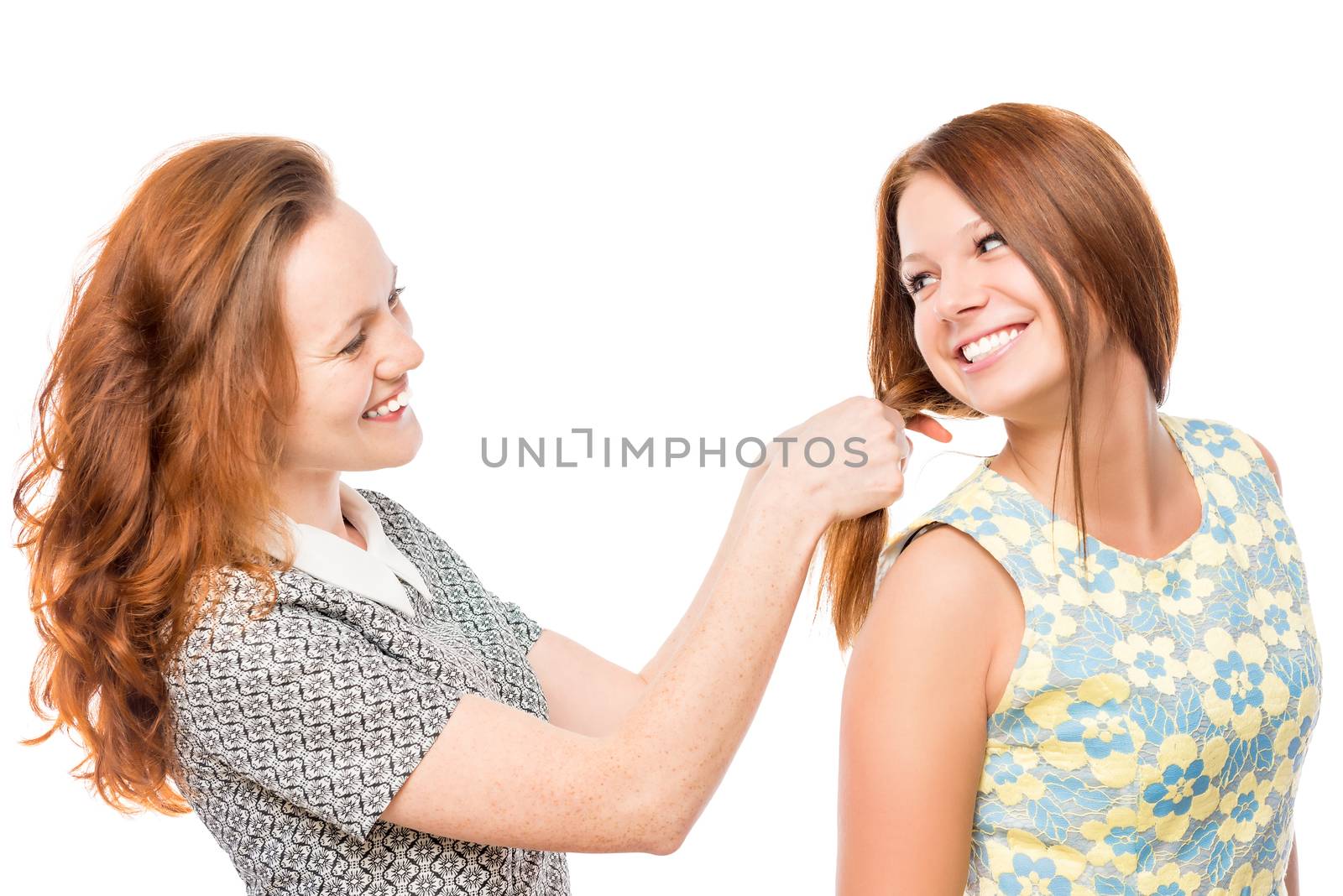 beautiful girl doing hairstyle to her friend on the white background