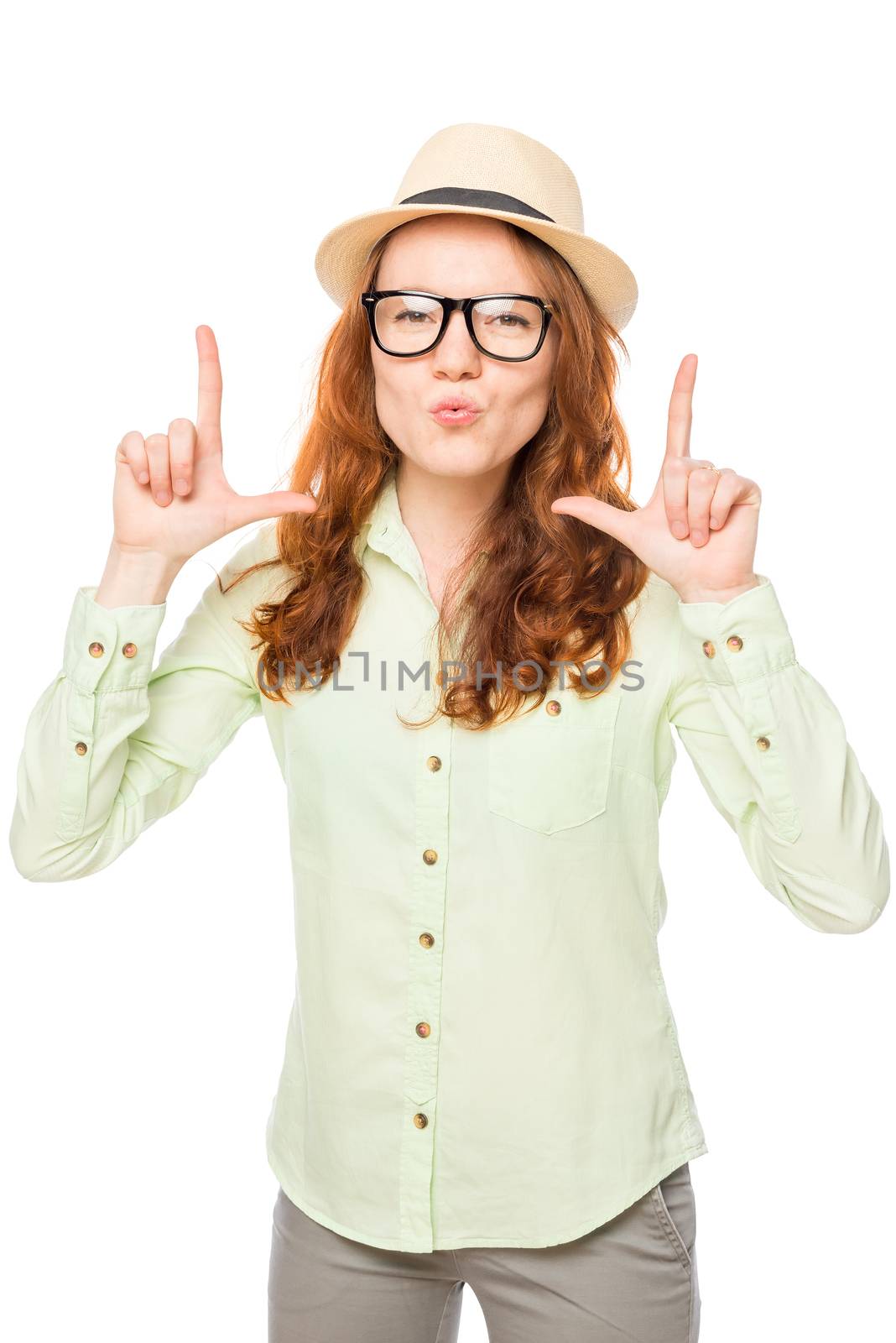 focused girl with a hat posing against white background