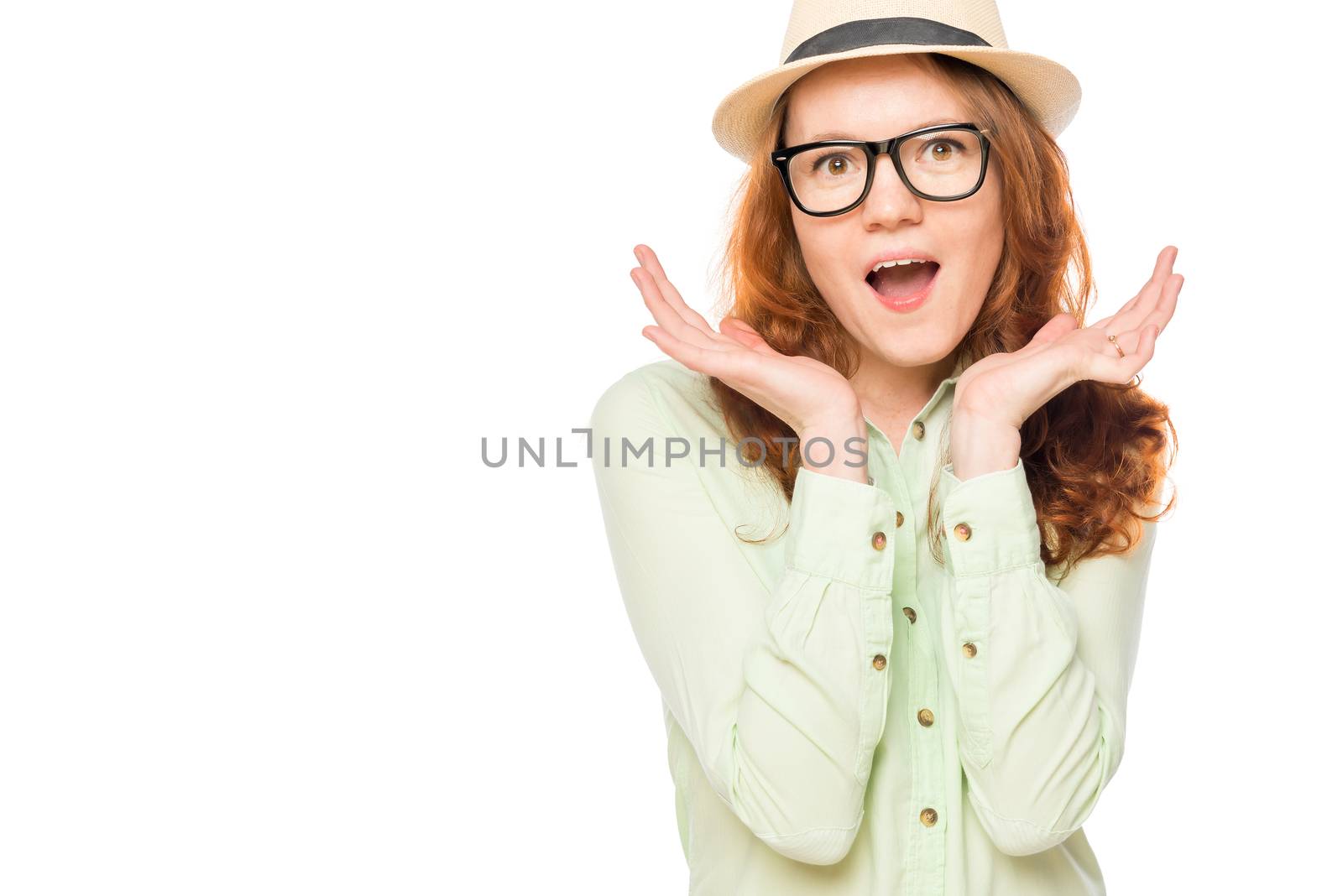 Surprised girl in the hat on a white background