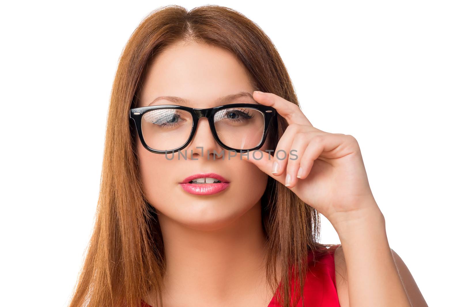 young brunette woman adjusts glasses, face closeup