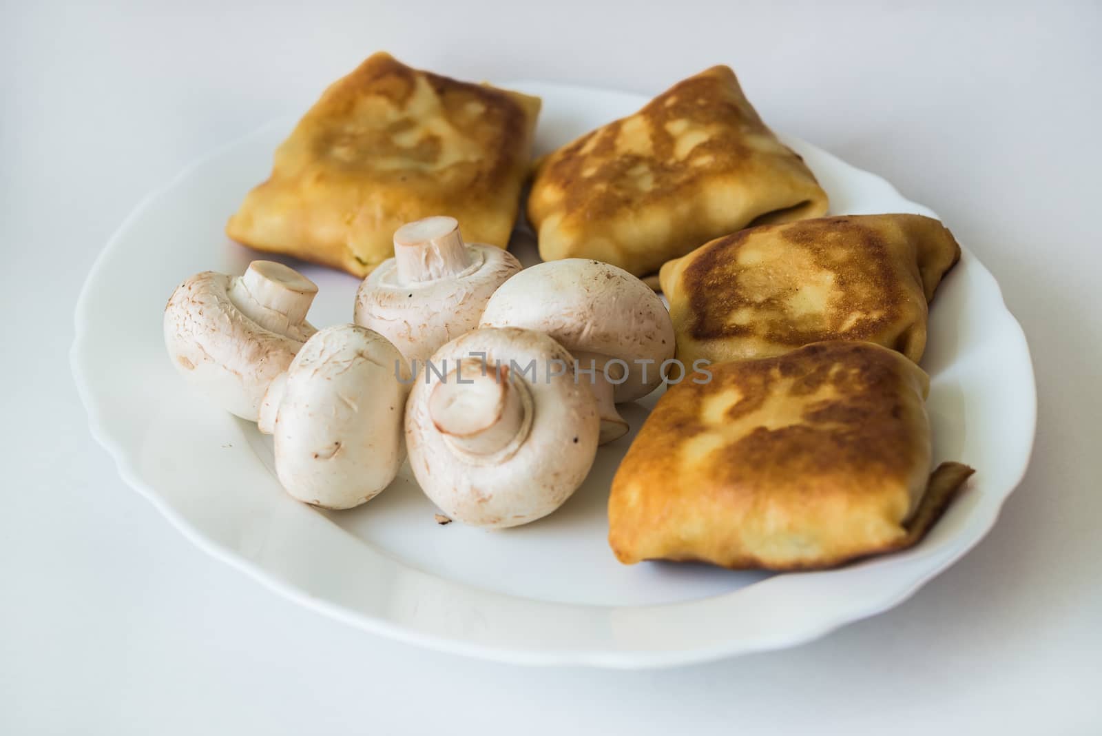 Pancakes with fillings and mushrooms on plate by okskukuruza