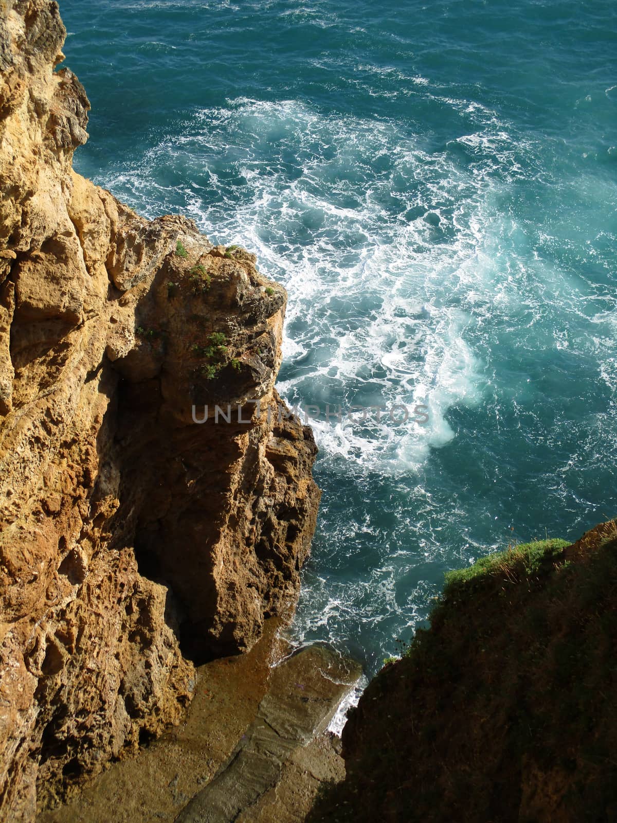 view from above of the waves on the rocks