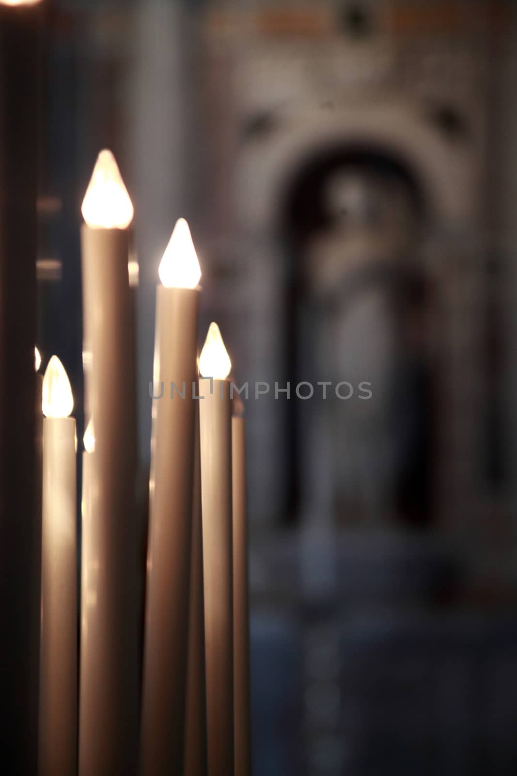 lighted candles in the cathedral of Pisa, Tuscany, Italy