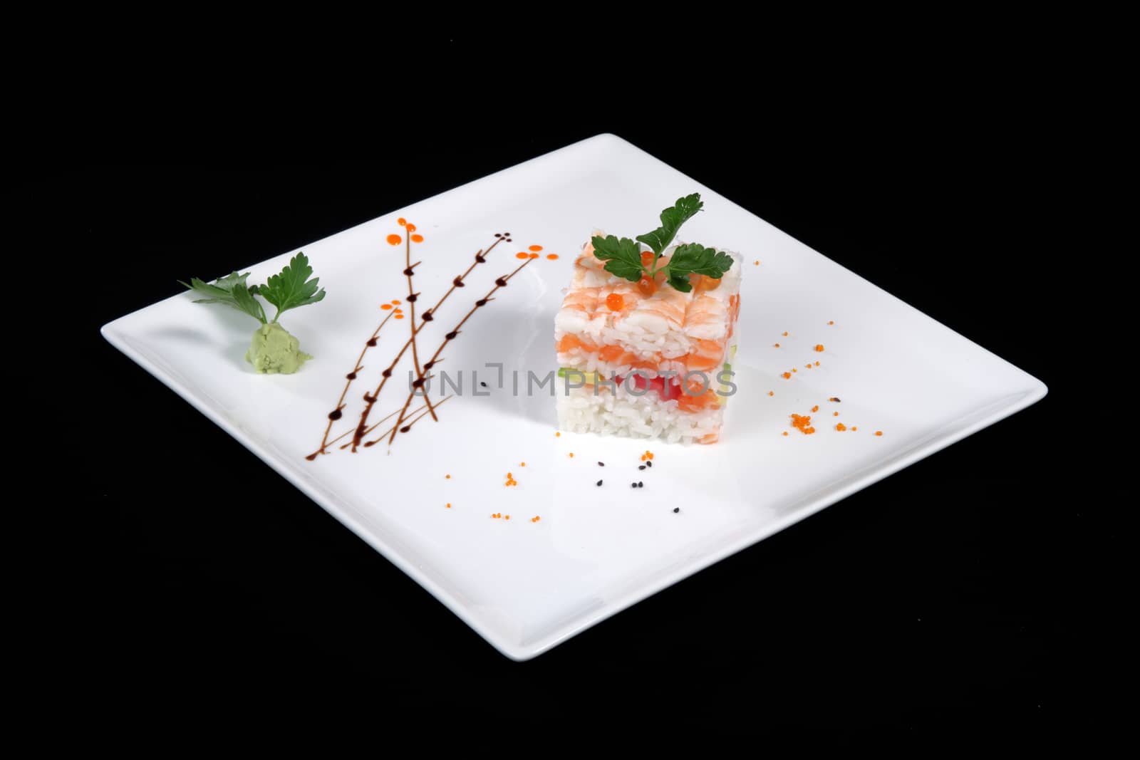 mixed sushi on white plate, black background