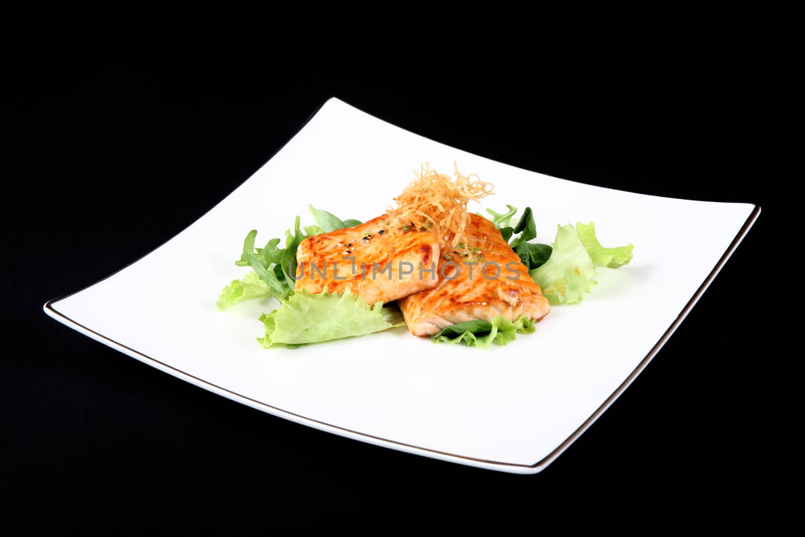 grilled salmon on square plate, black background