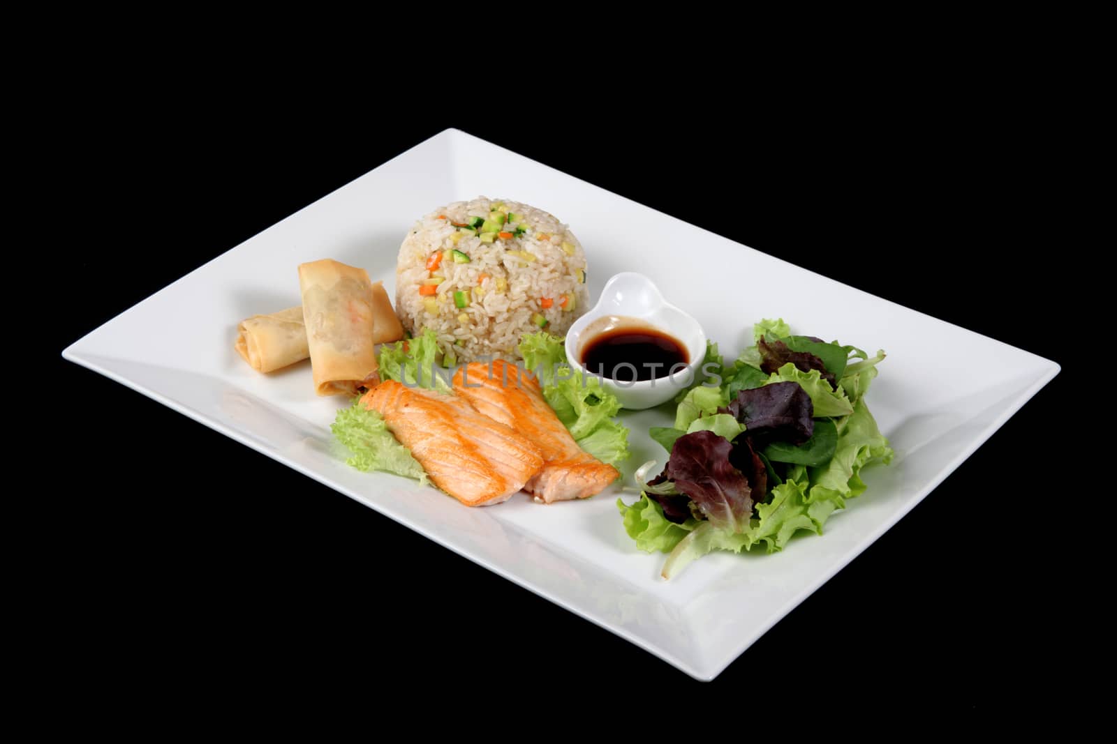 menu of grilled fish with rice and vegetables on white plate, on black backgrpound