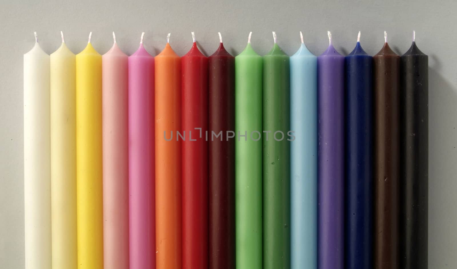 group of colorful cylindrical candles on a white background