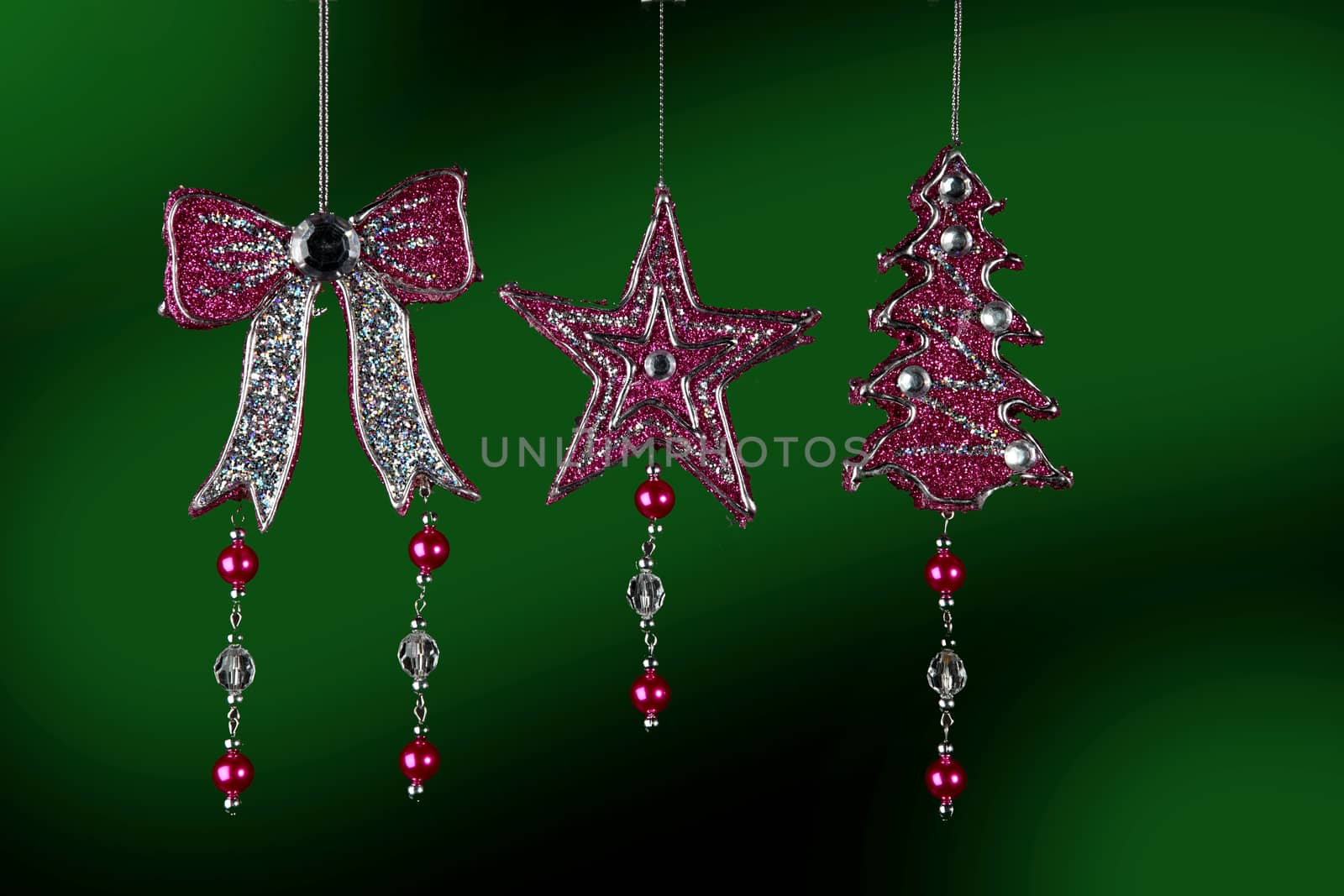 Christmas decorations to hang on the Christmas tree on a  green background