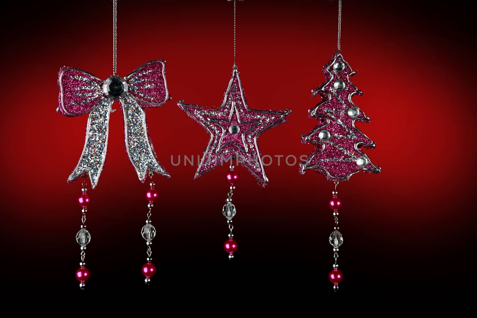christmas tree decorations on red by diecidodici