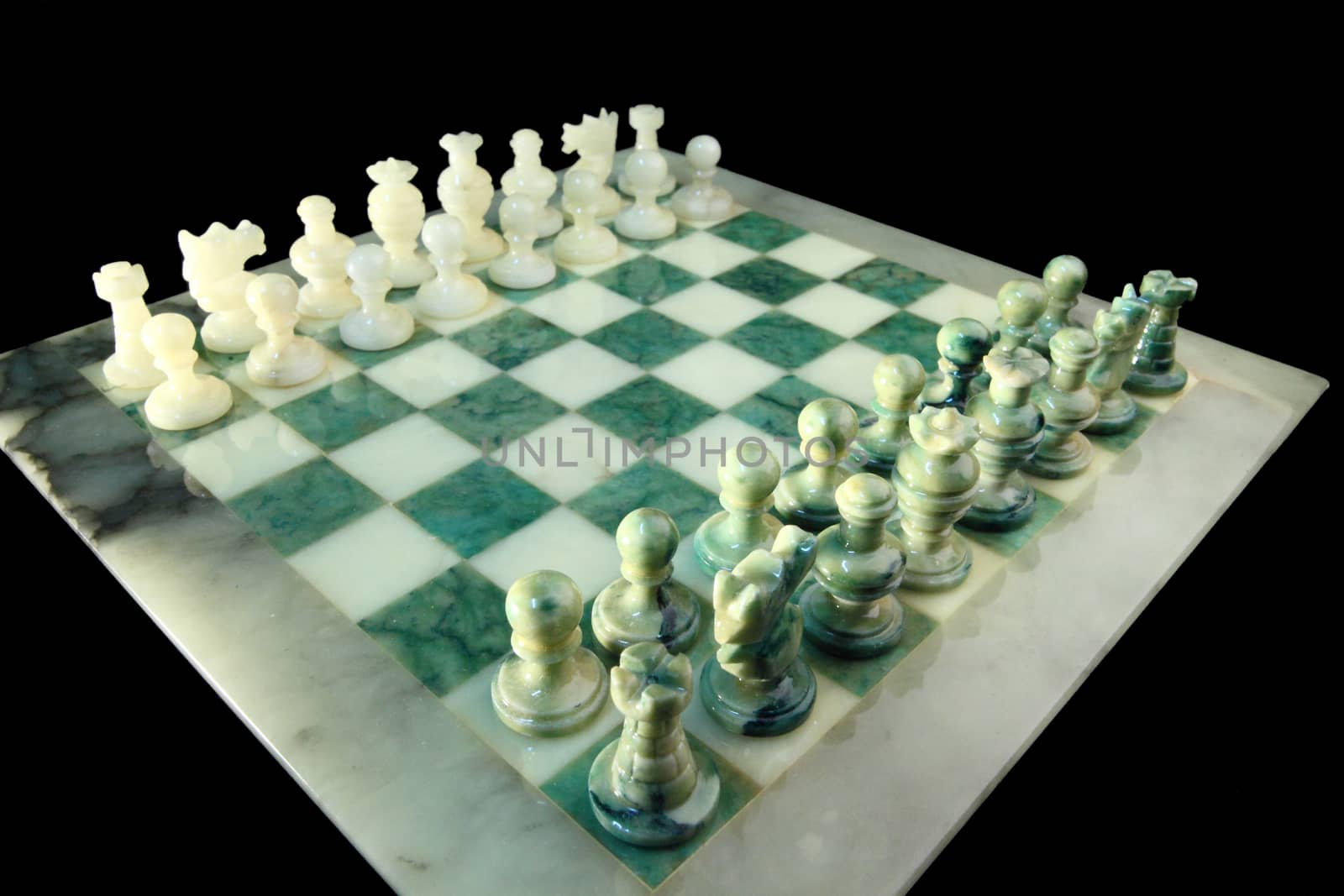 chessboard and alabaster chess on a black background