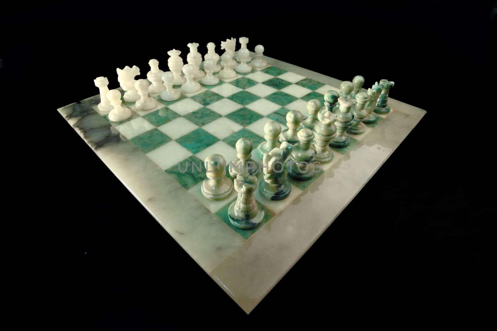 chessboard and alabaster chess on a black background