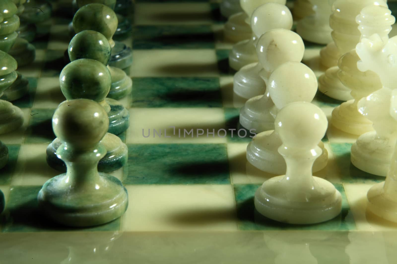 chessboard and alabaster chess on a black background