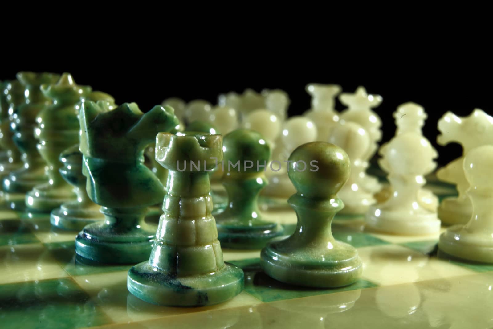 chessboard and alabaster chess on a black background