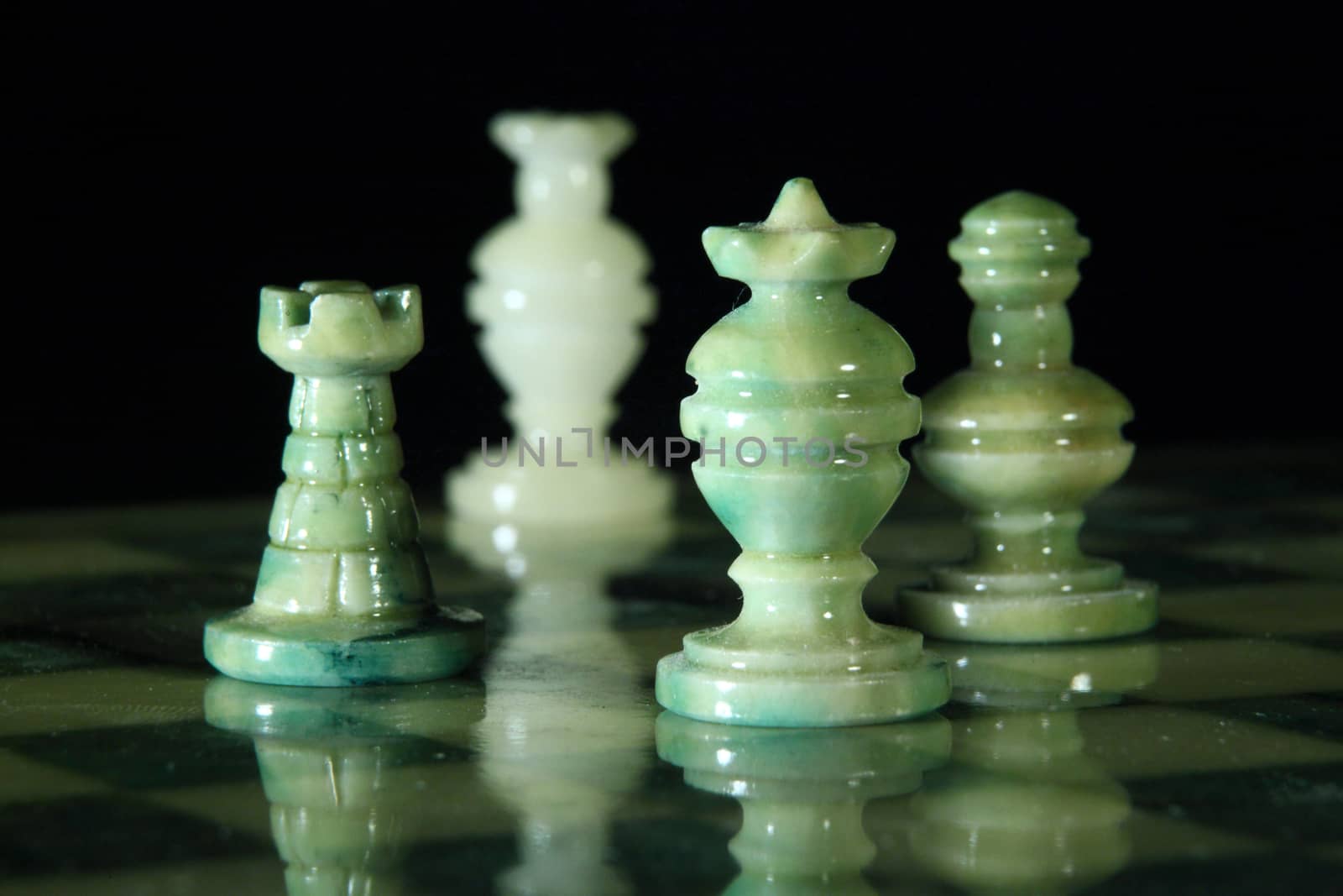 chessboard and alabaster chess on a black background