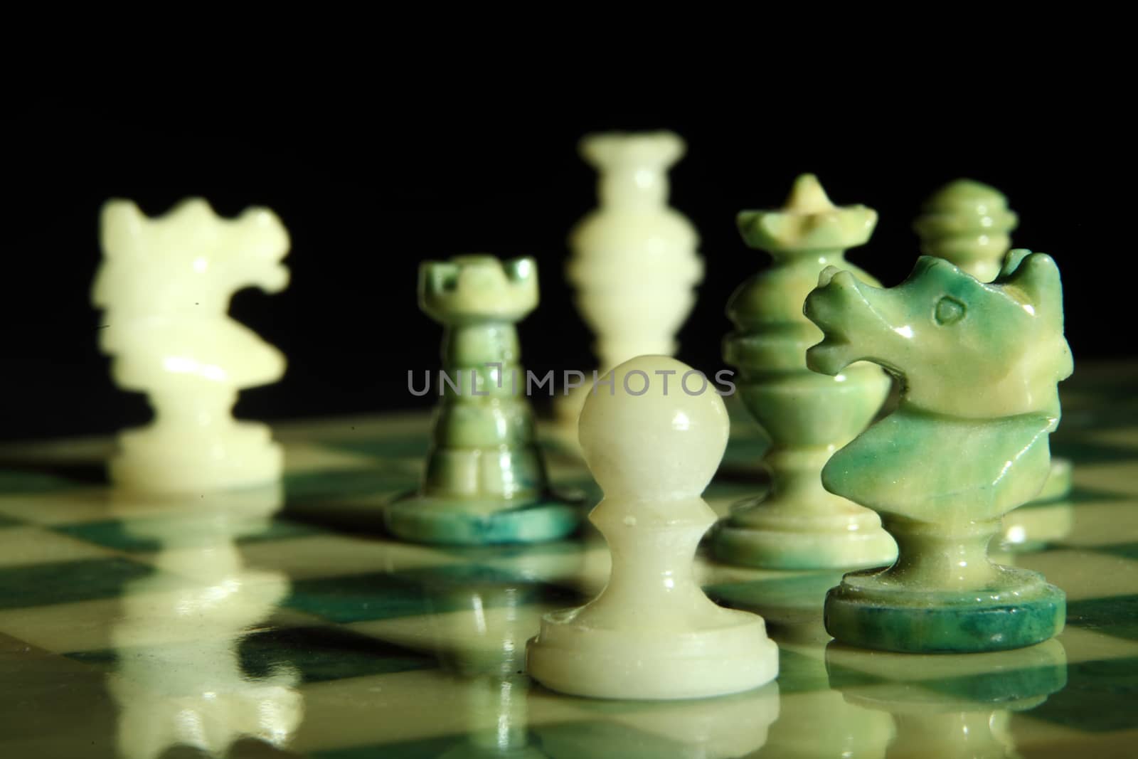 chessboard and alabaster chess on a black background