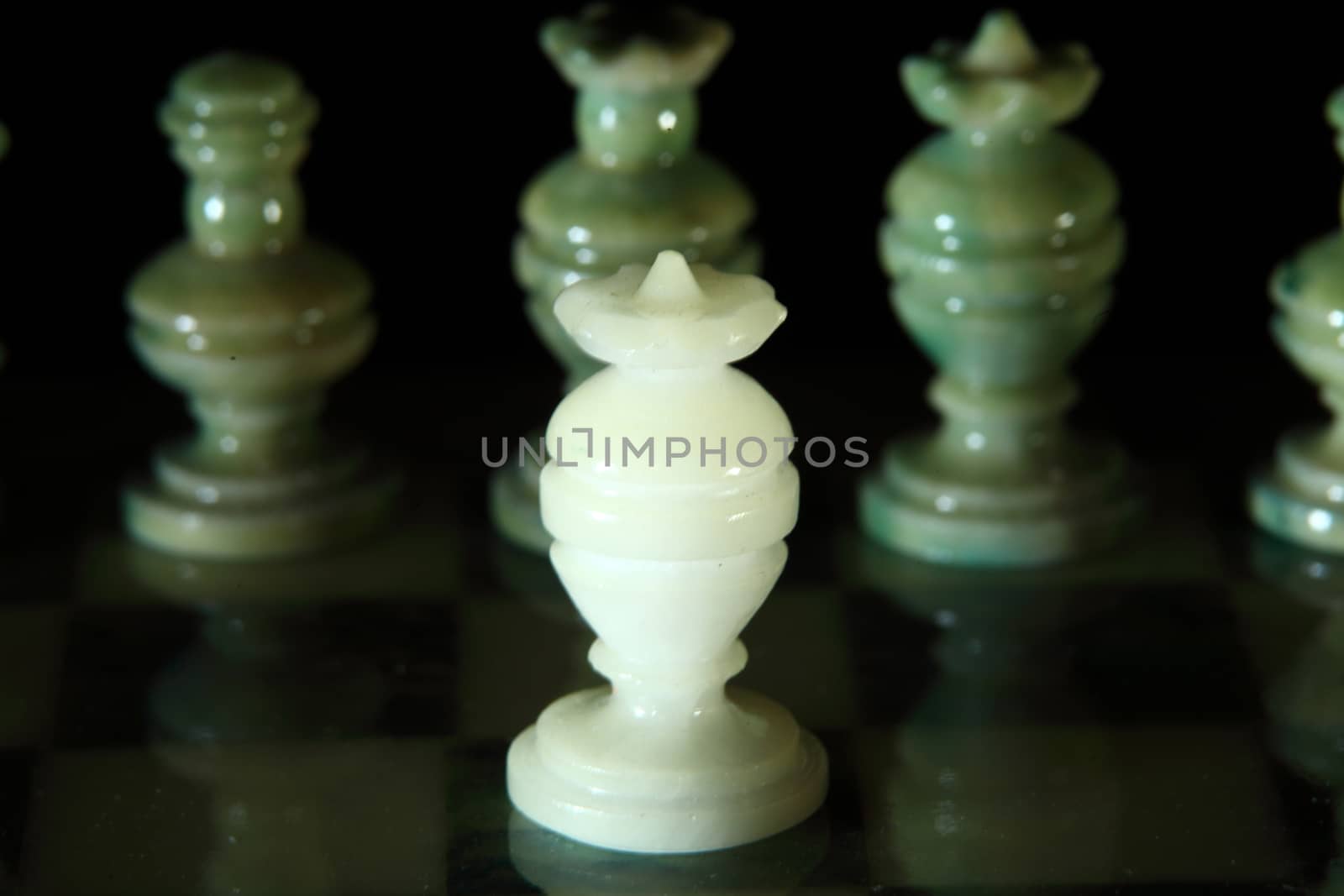 chessboard and alabaster chess on a black background