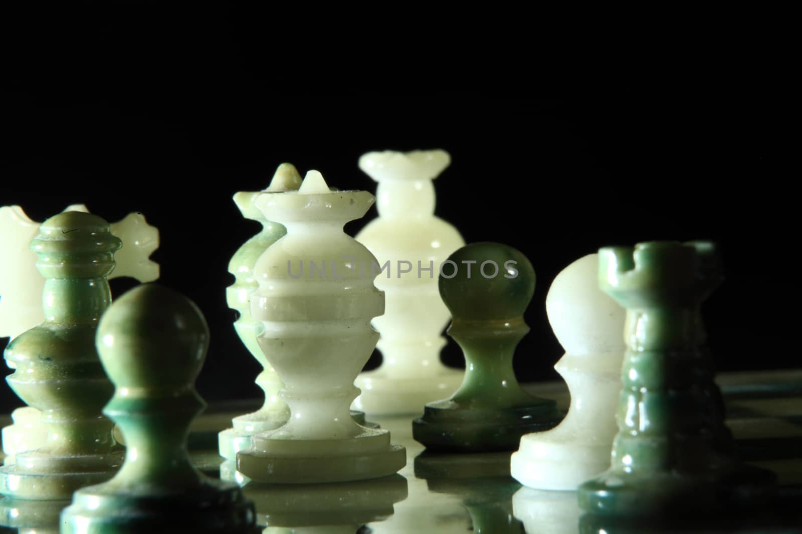 chessboard and alabaster chess on a black background