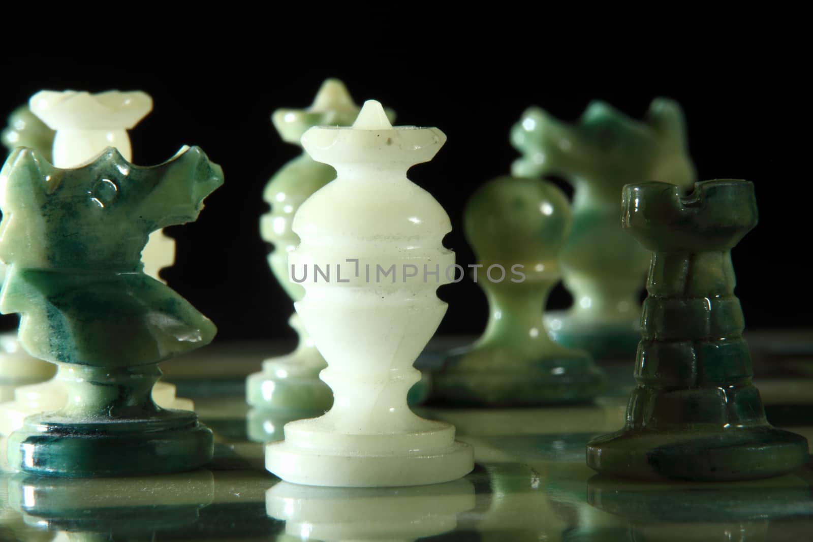 chessboard and alabaster chess on a black background