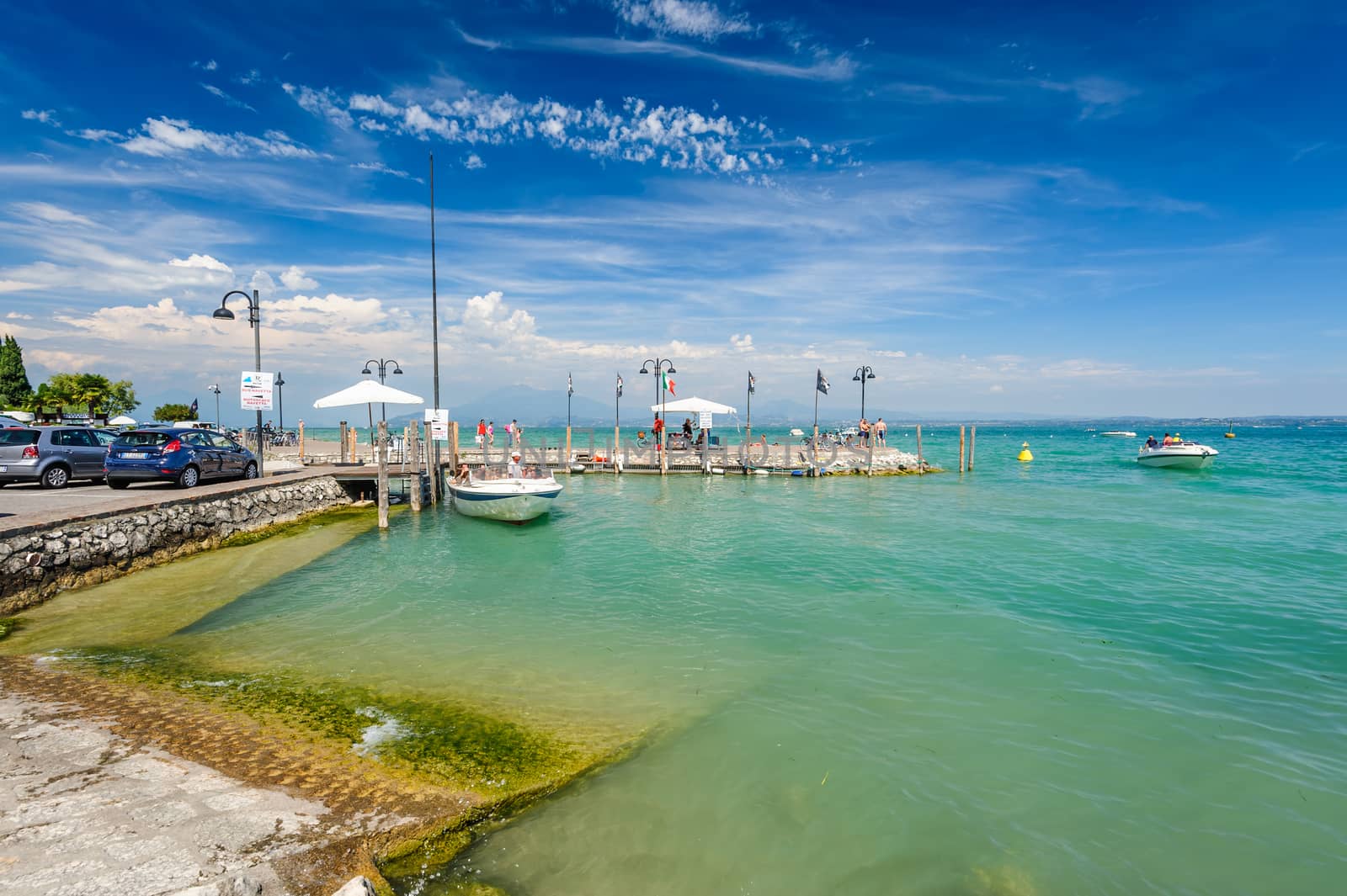 Desenzano, Lombardy, northern Italy, 15th August 2016: Small yachts and boats in harbor of Desenzano del Garda, lake Garda, Italy