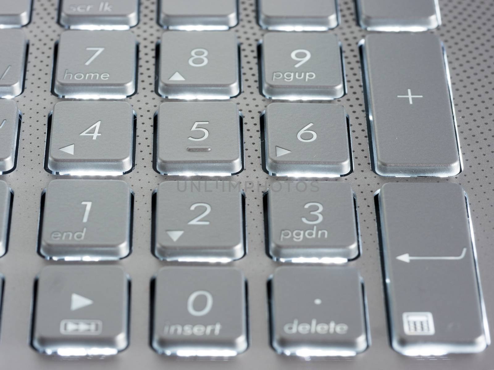 Number keys on silver keyboard of laptop by fascinadora