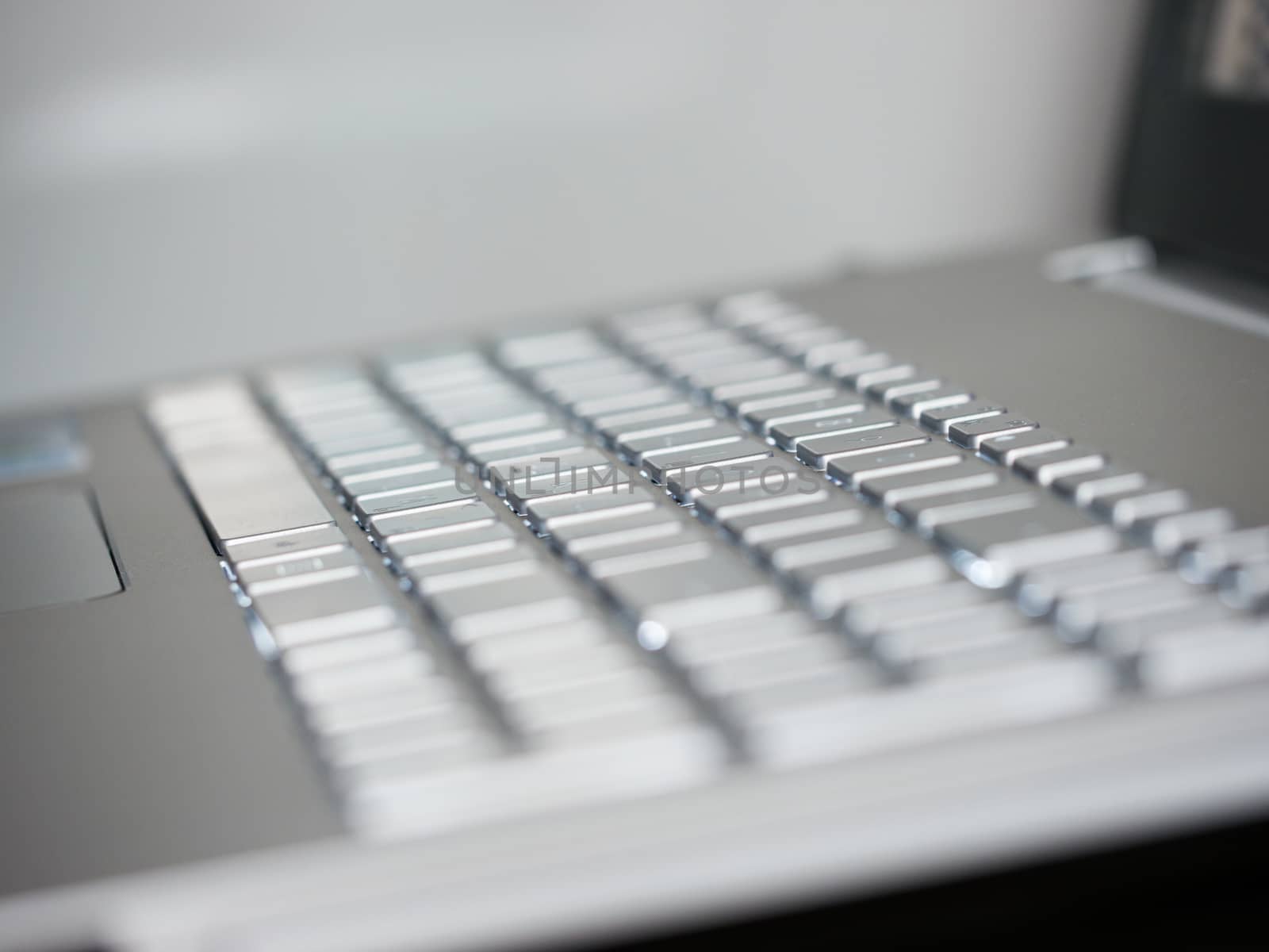 Abstract close-up silver laptop keyboard with copy space. Shallow DOF