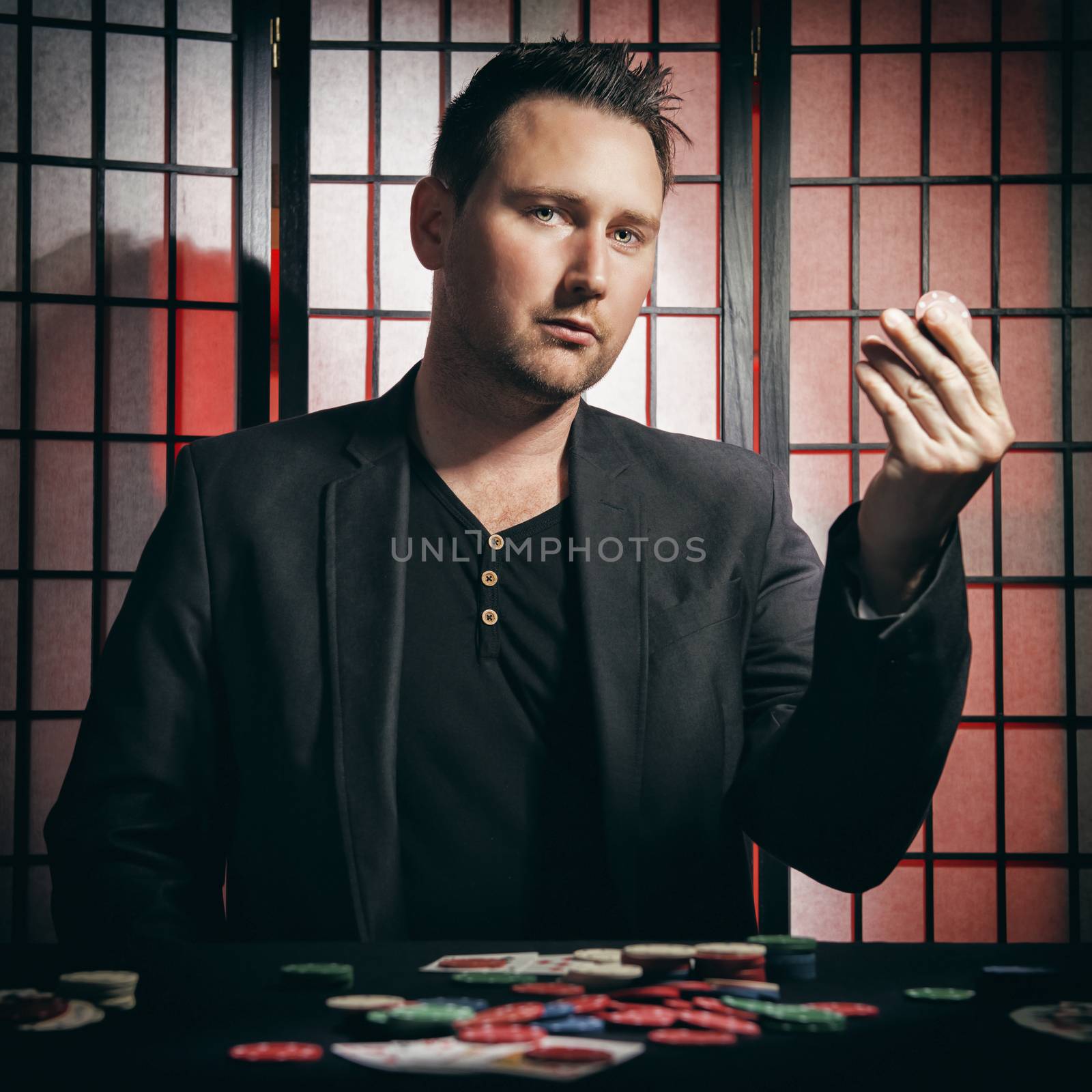 Concept: A high stakes poker player is winning big and feeling a little to confident against his opponents. He becomes overconfident and arrogant, showing of his chip stakes. Cinematic portrait.