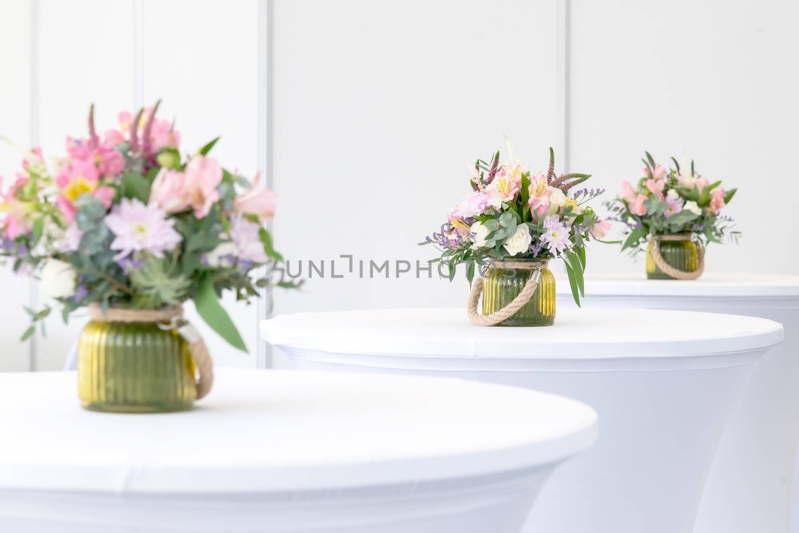 beautiful flower arrangement on white festive tables by vlaru