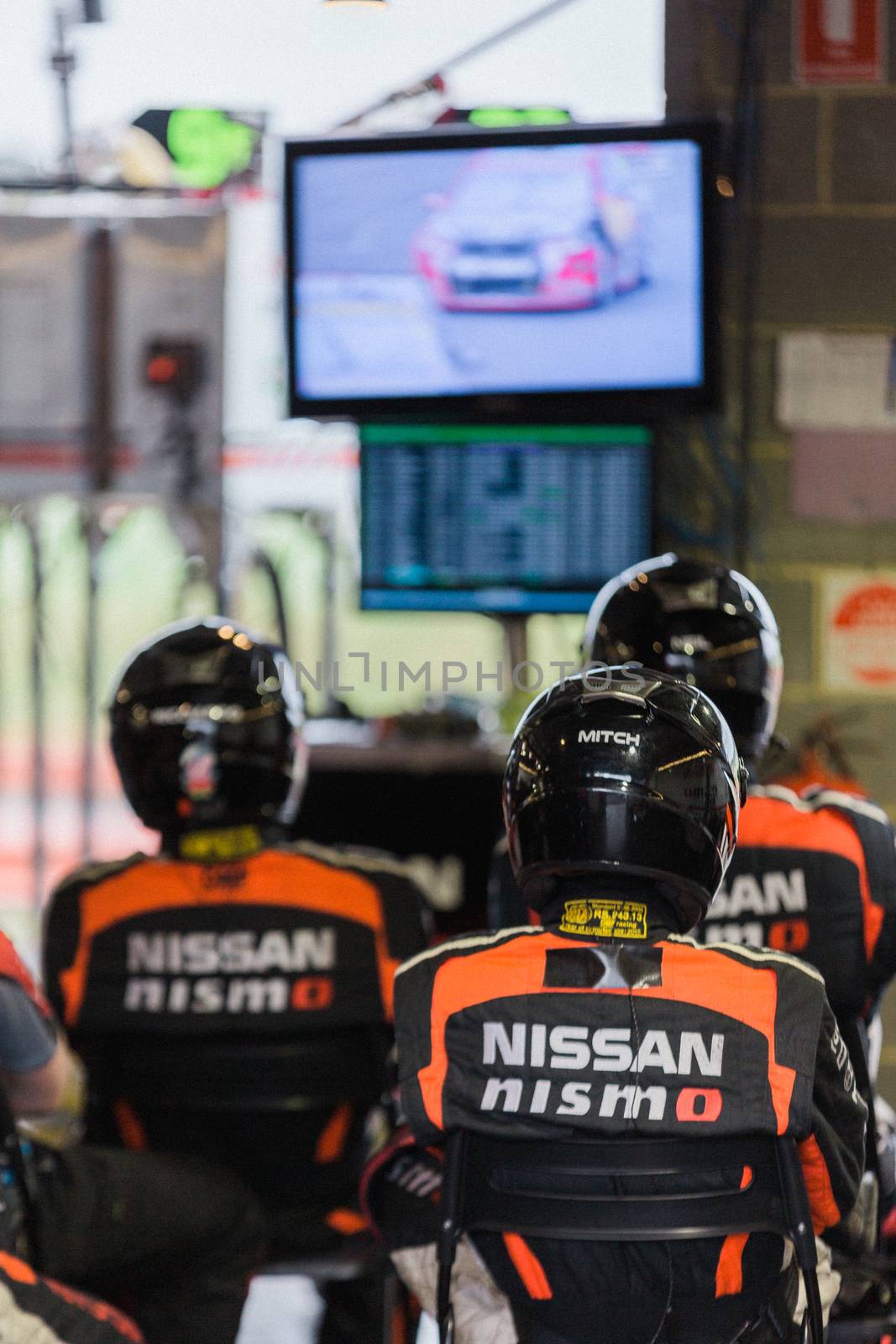 MELBOURNE/AUSTRALIA - SEPTEMBER 17, 2016: Team engineers hard at work at the Wilson Security Sandown 500 'Retro' Endurance race at Sandown raceway.