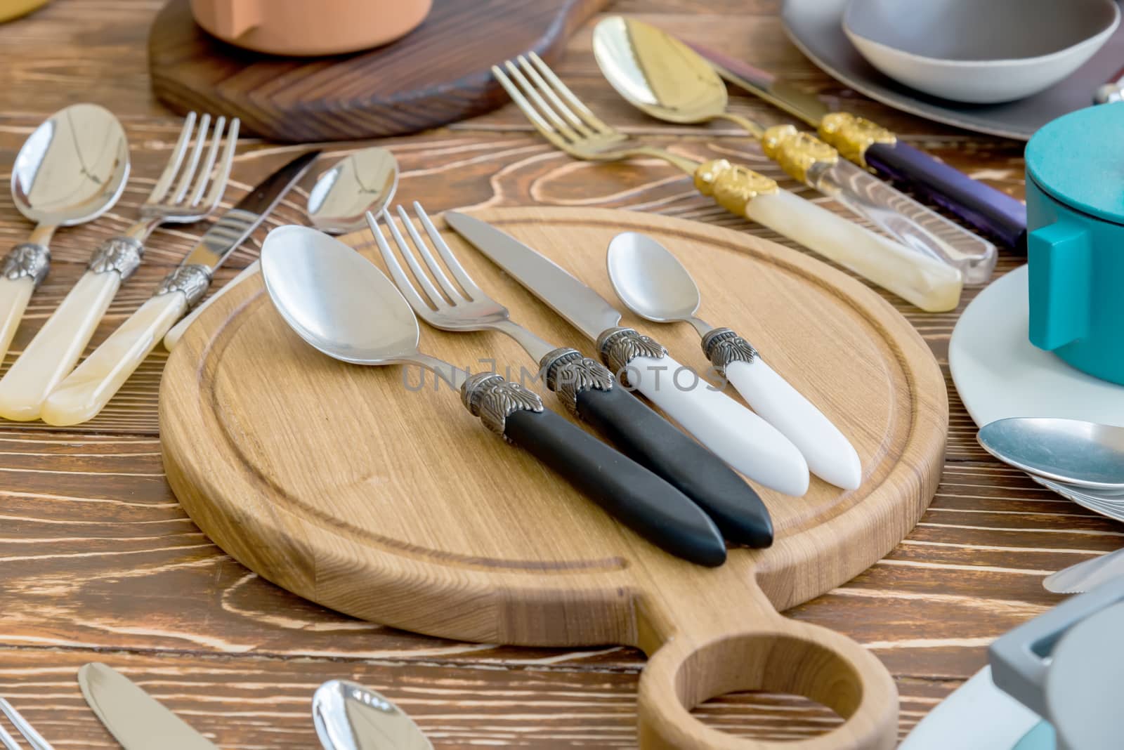 the Fork and Spoon and Table Knife on the wooden Cutting board