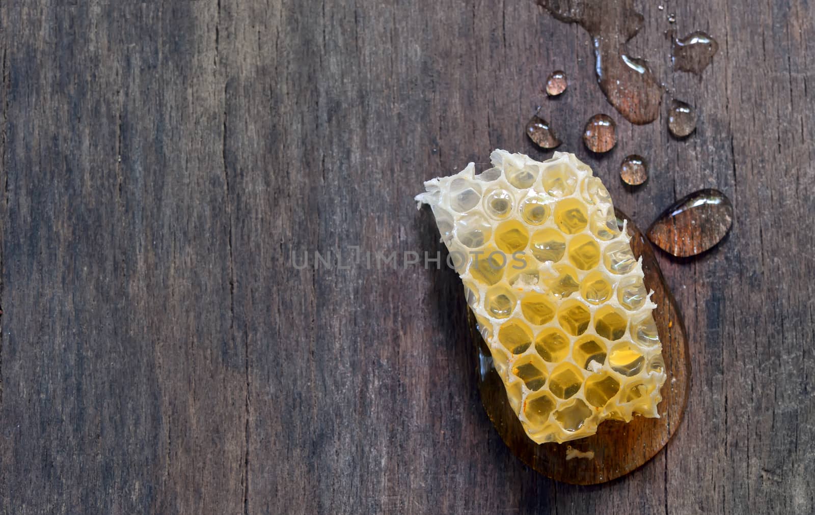 sweet honeycombs with honey isolated on old wooden background