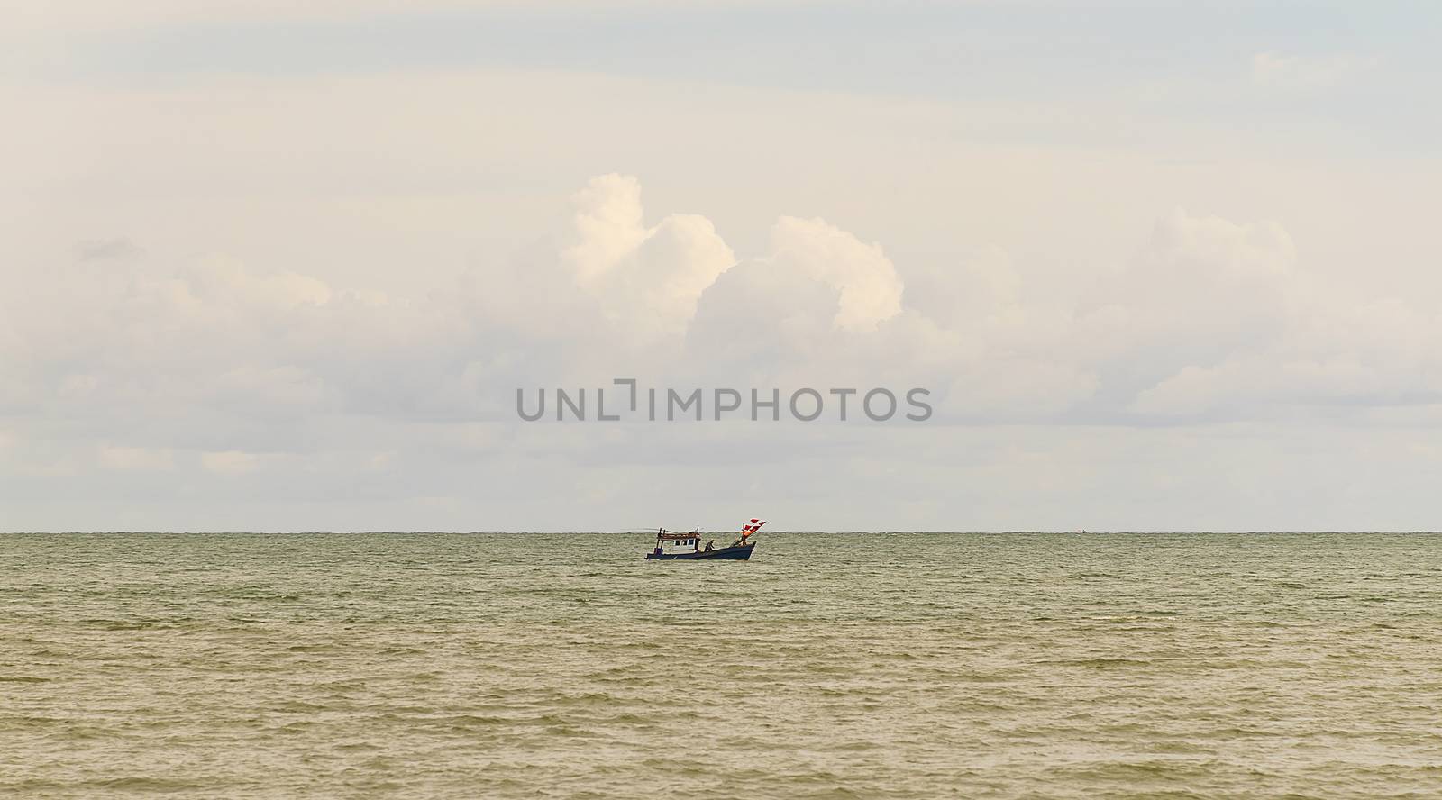 boat in blue sea with clouds sky background in Thailand. Relaxing moments in summer seasons travel. Tropical nature in vacation time.