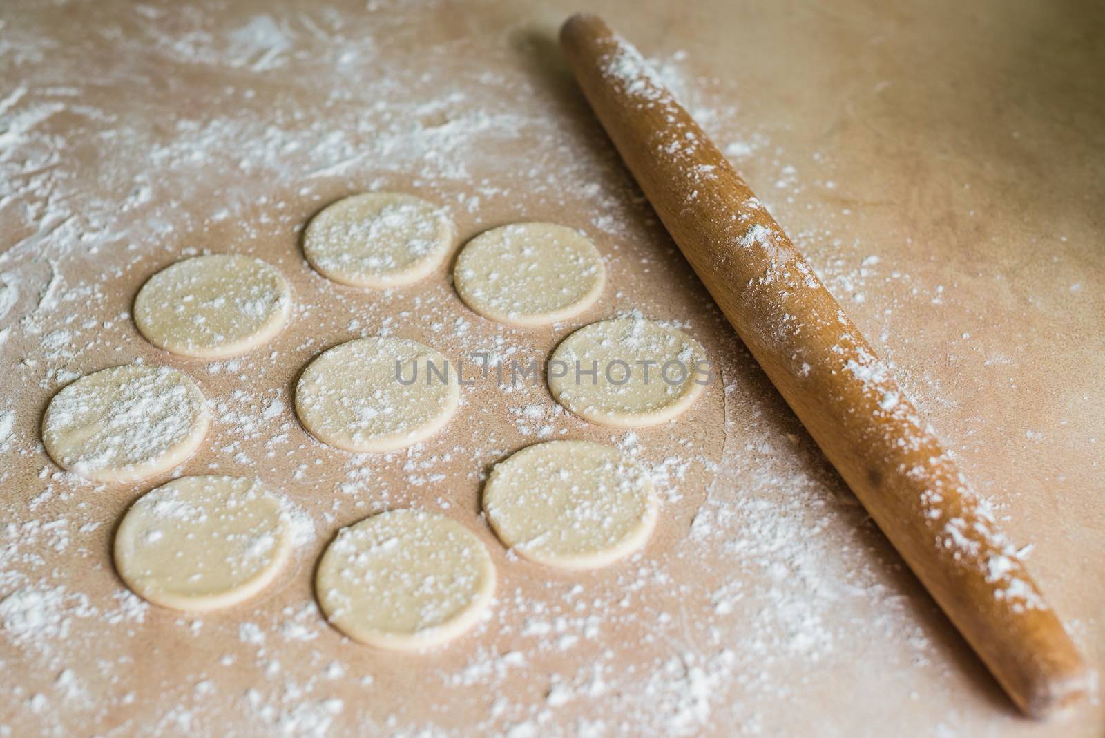 Dough circles and rolling pin by okskukuruza