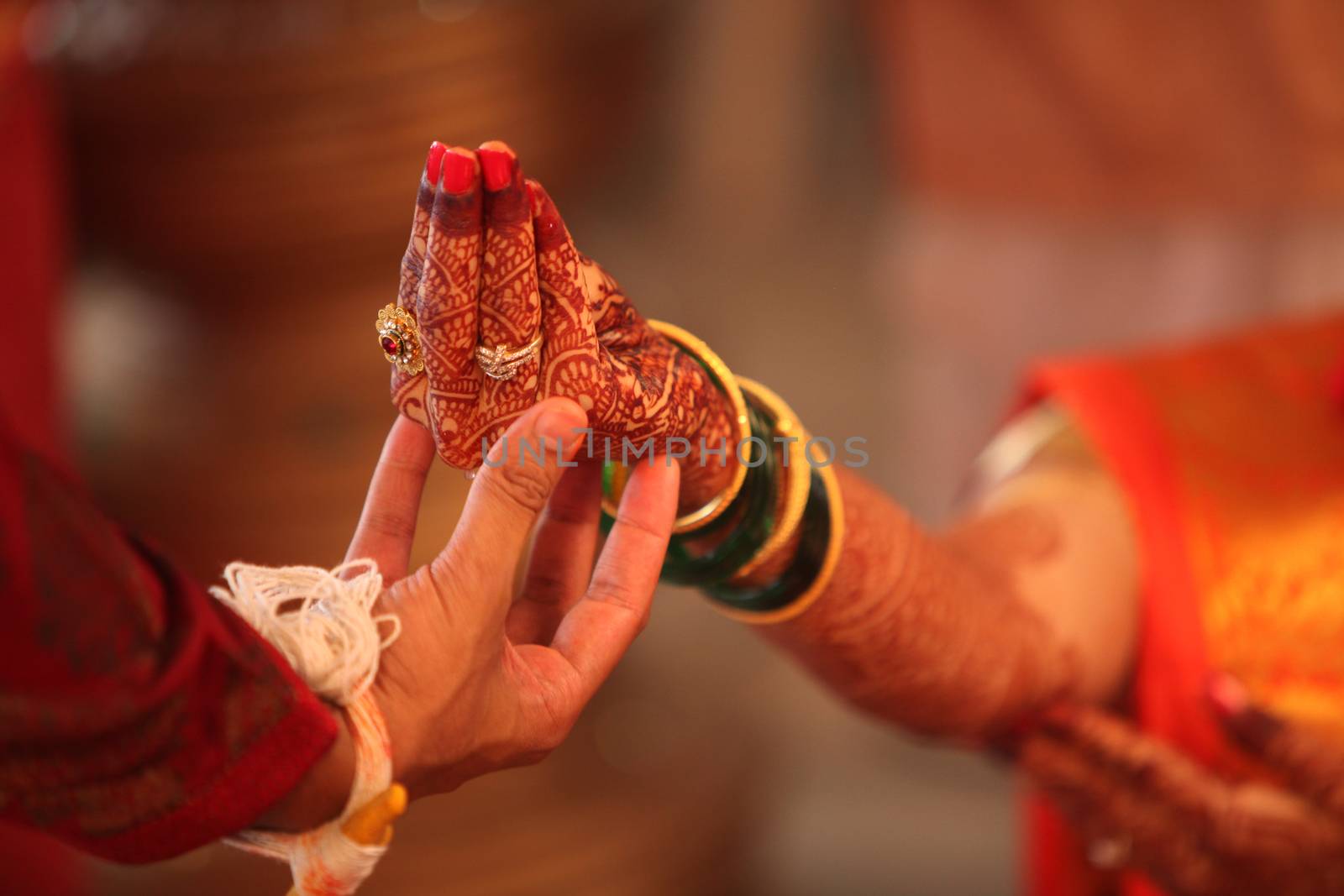 An Indian groom holding the bride's hand during a traditional hindu wedding ritual