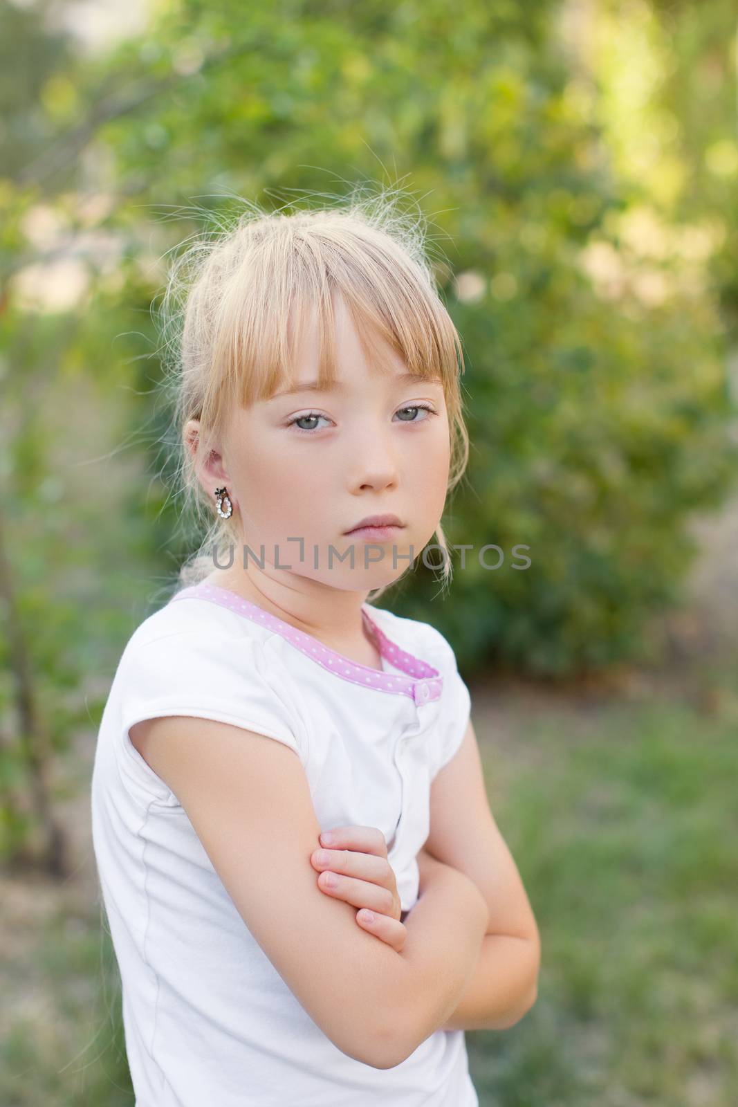 Portrait of the girl in the green bushes, close-up