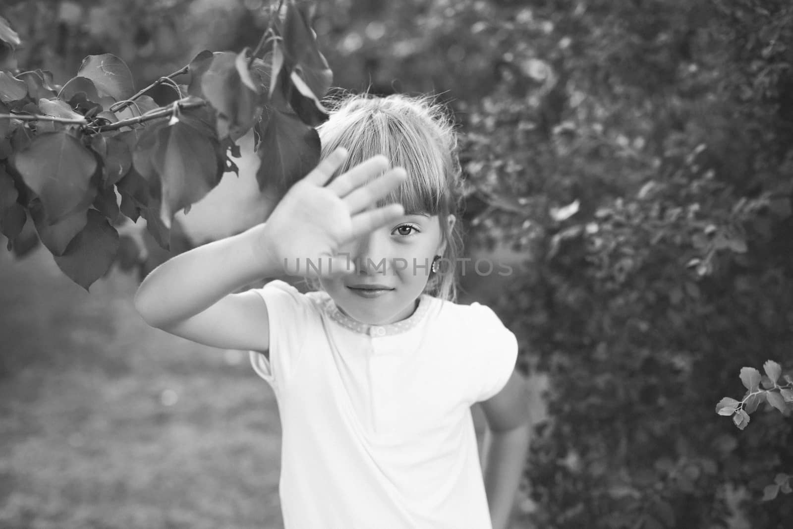 Portrait of the girl in the green bushes, close-up