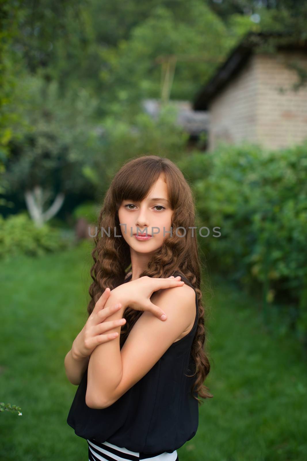 Girl with long hair on nature in a warm summer day