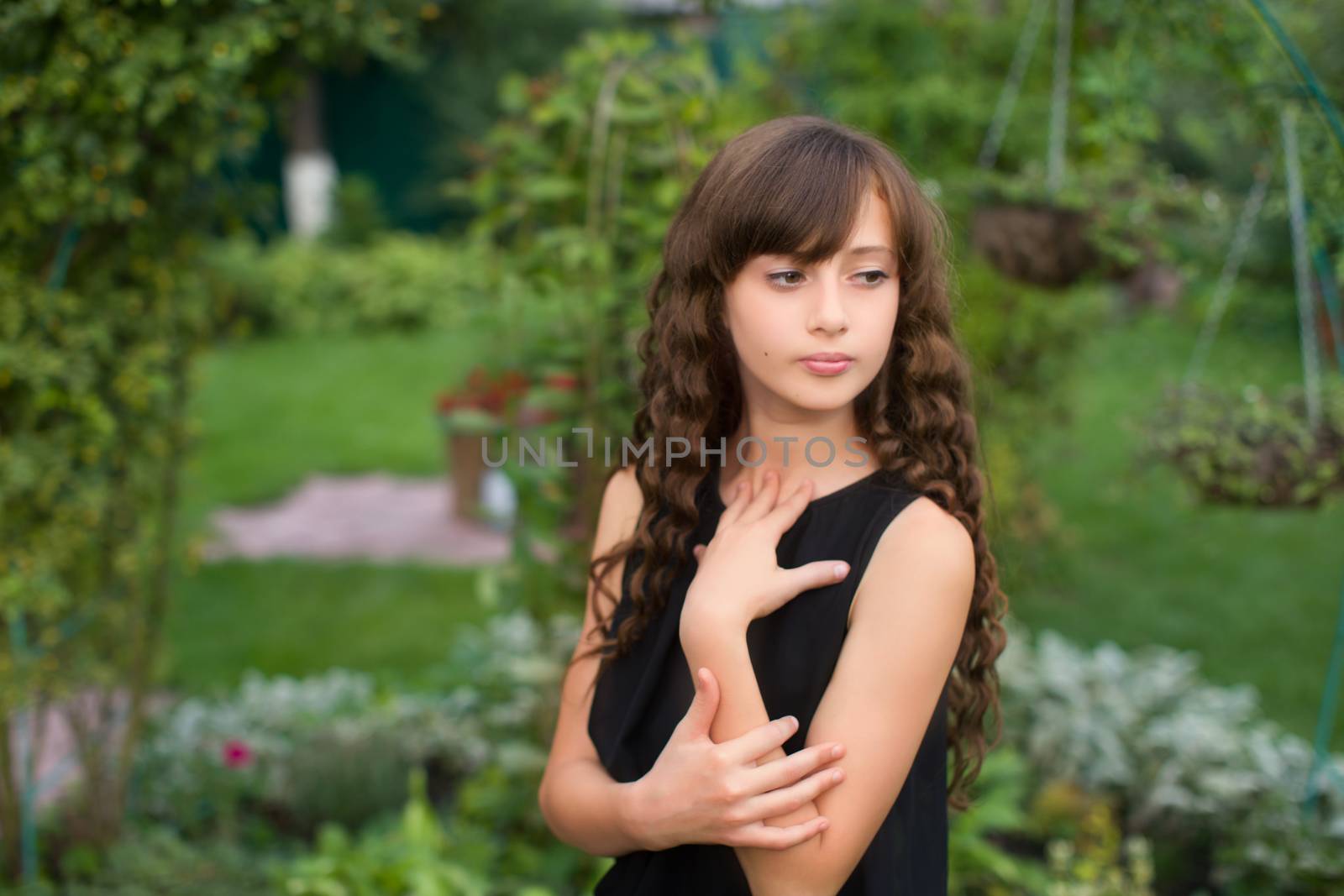 Girl with long hair on nature in a warm summer day