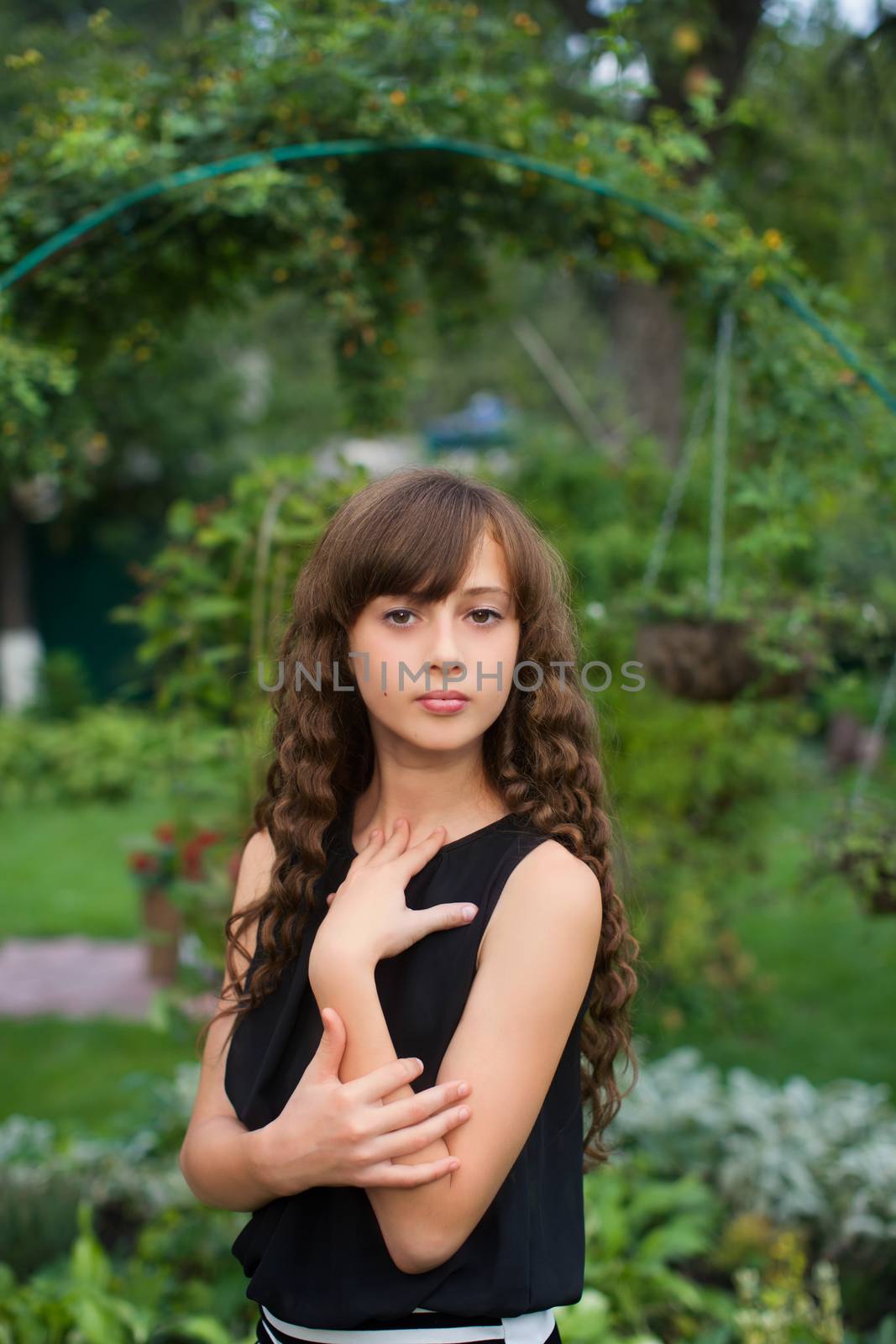 Girl with long hair on nature in a warm summer day