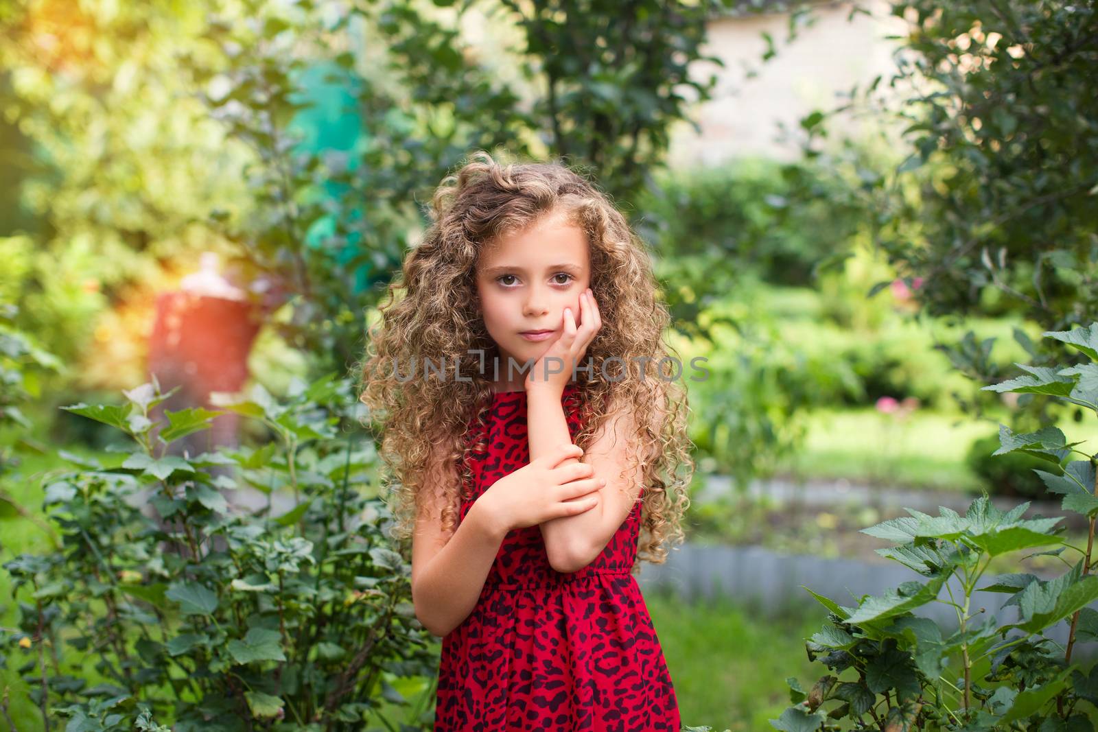 Girl with long hair on nature in a warm summer day