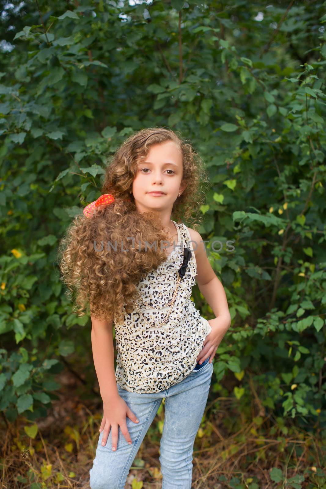 Girl with long hair on nature in a warm summer day