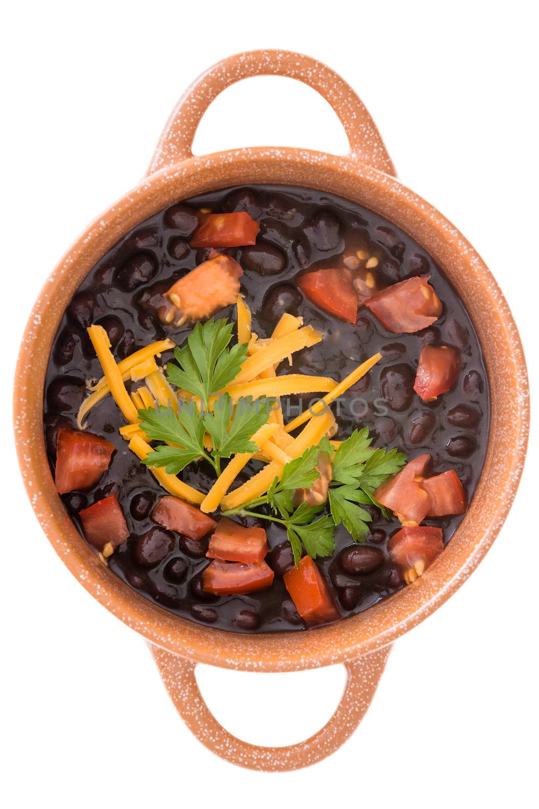 Bowl of black bean soup garnished with cheese by coskun