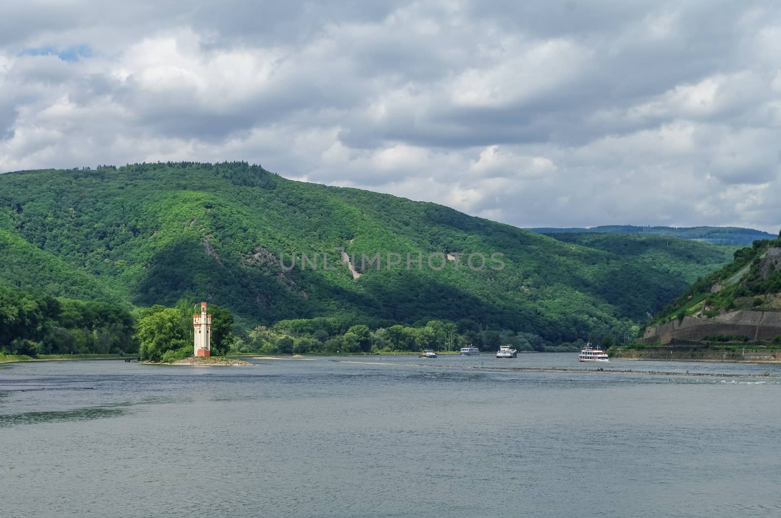 Ship, medieval castle Mouse Tower (Mäuseturm) and vineyards on the slope of Rhine river bank, Bingen am Rhein, Germany