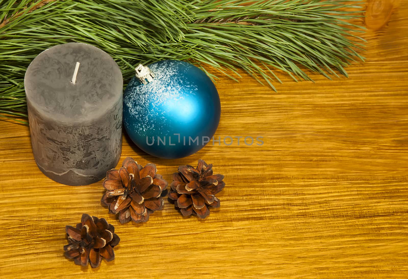 Composition with fir cones and grey candle on wooden background by RawGroup