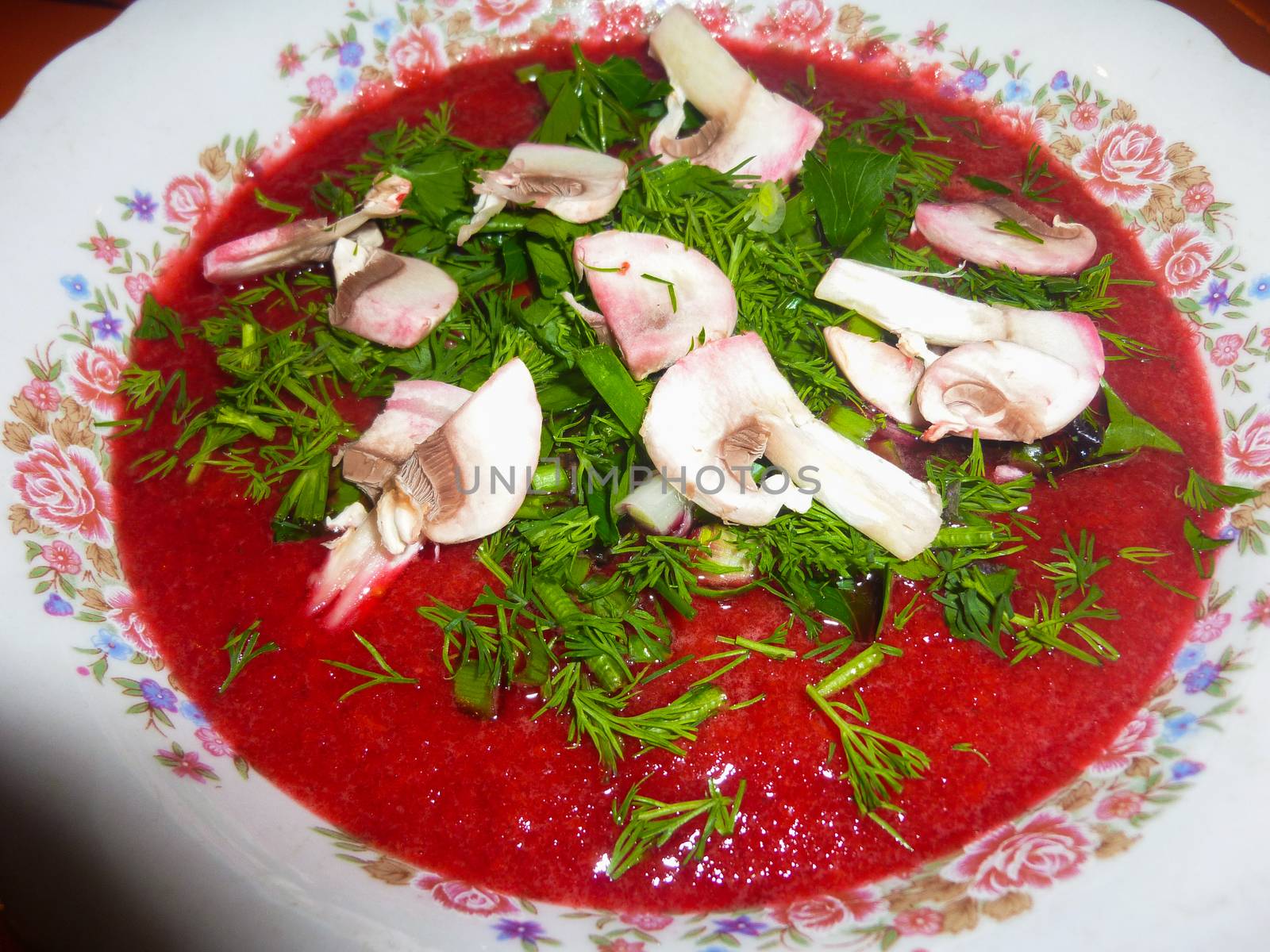 fresh raw tomato soup with champignons, close up by evolutionnow