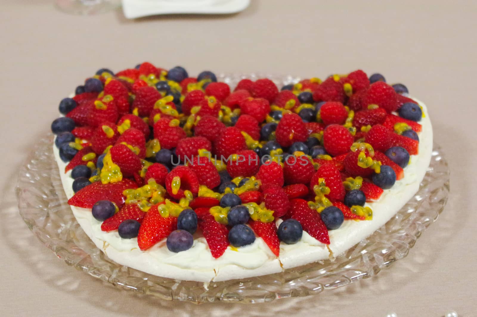 homemade cake with Strawberries and blueberries for Valentine's Day heart shaped on a glas plate   tablecloth by evolutionnow