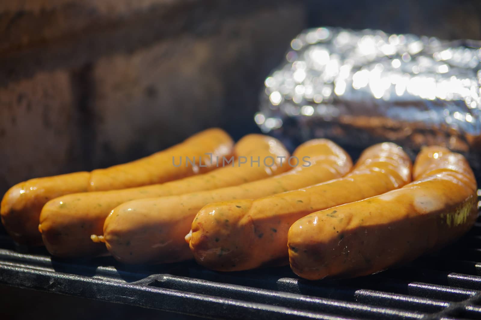 row of grilled sausages on a grill. bratwurst close up