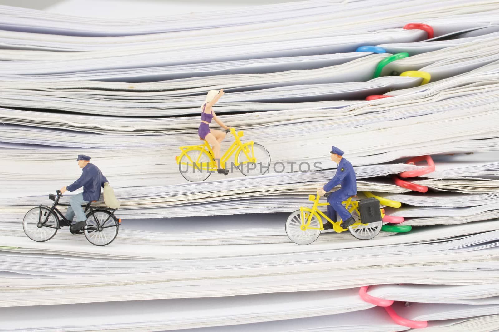 Close up postmen and woman cycling on pile overload paperwork by eaglesky